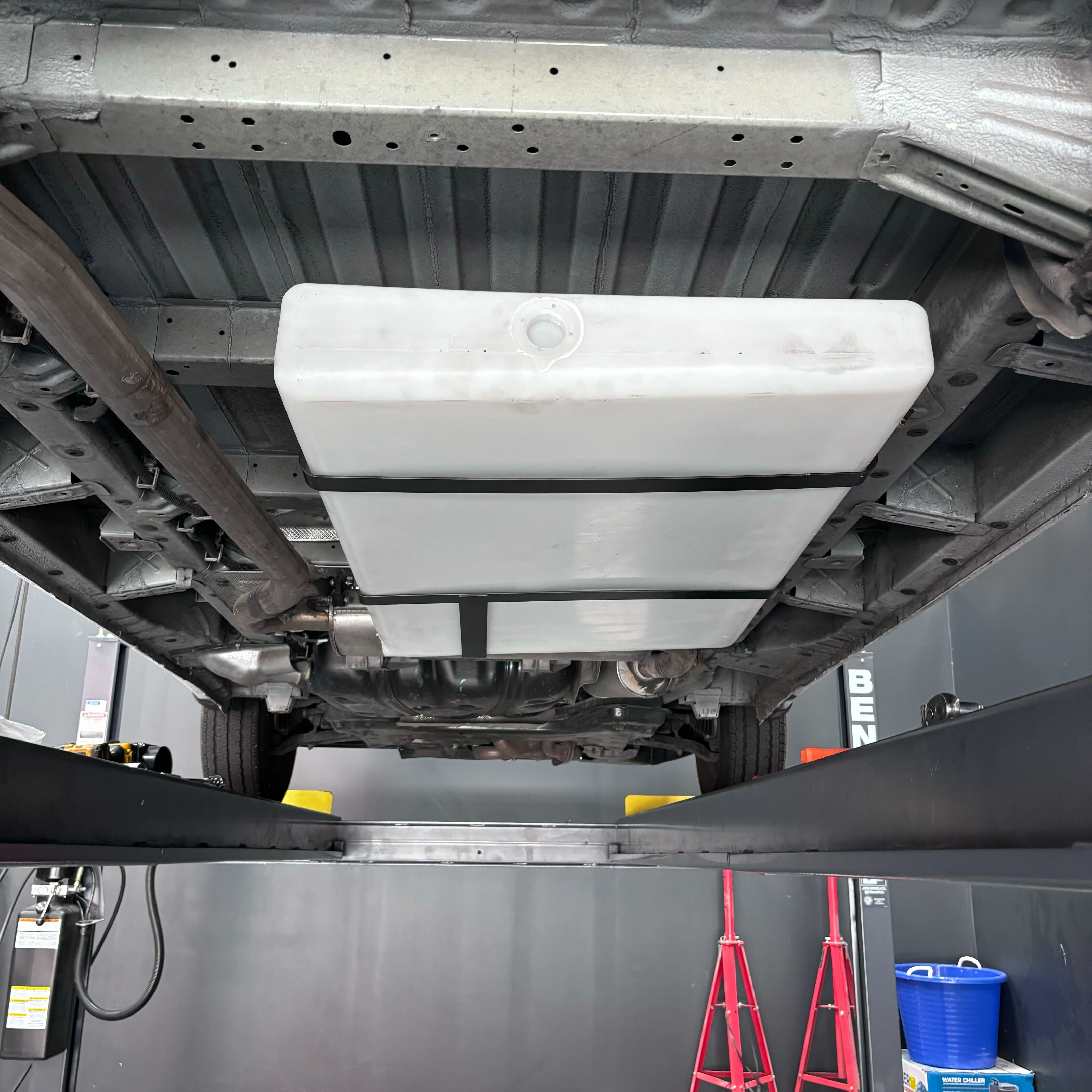 36-gallon undercarriage fresh/grey water tank installed under a Ford or Dodge/Ram Promaster, showcasing its sturdy design.