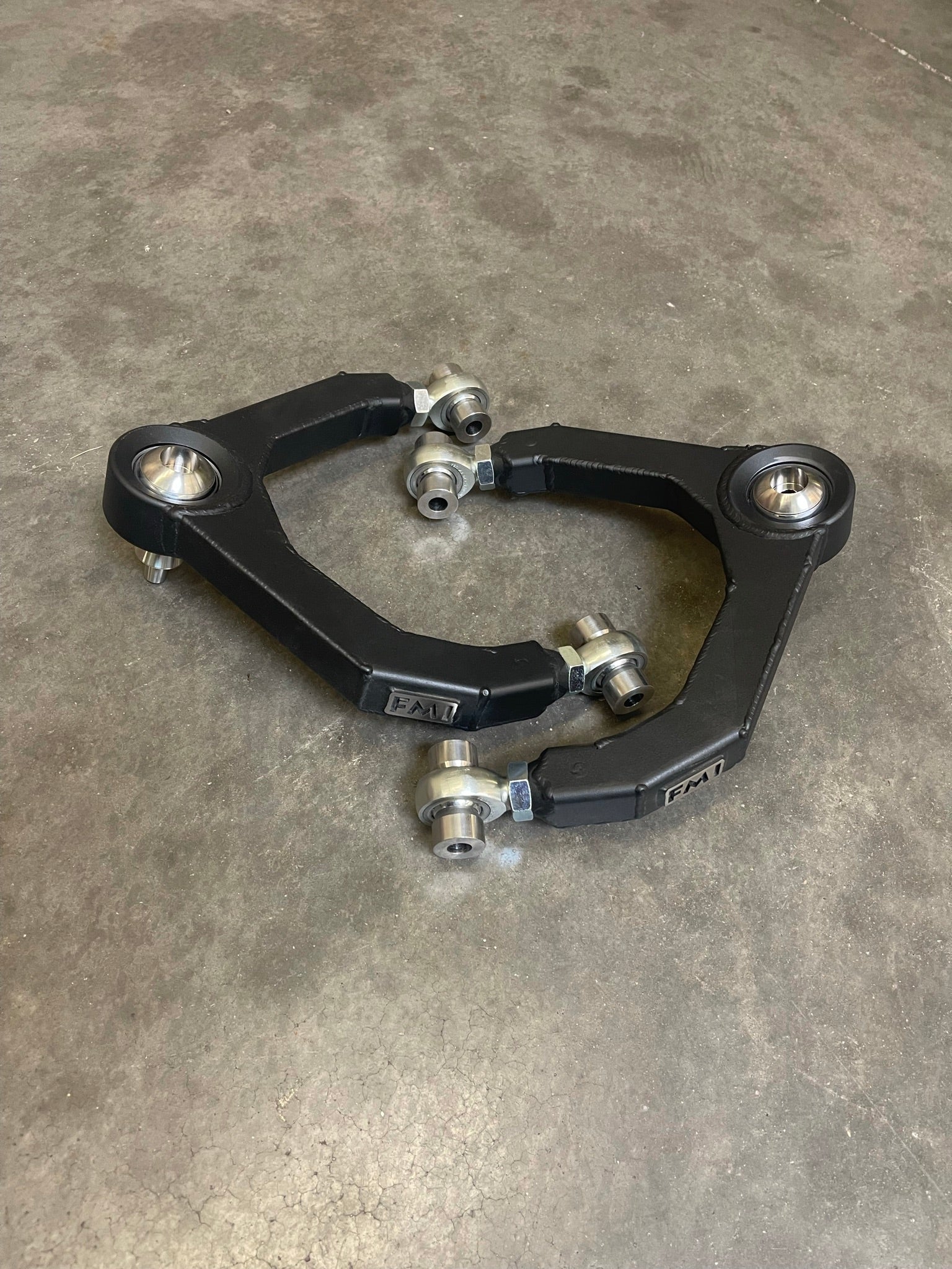 Fabricated upper arm kit for 2010-2014 Raptor, featuring durable construction and high-quality bushings for enhanced performance.