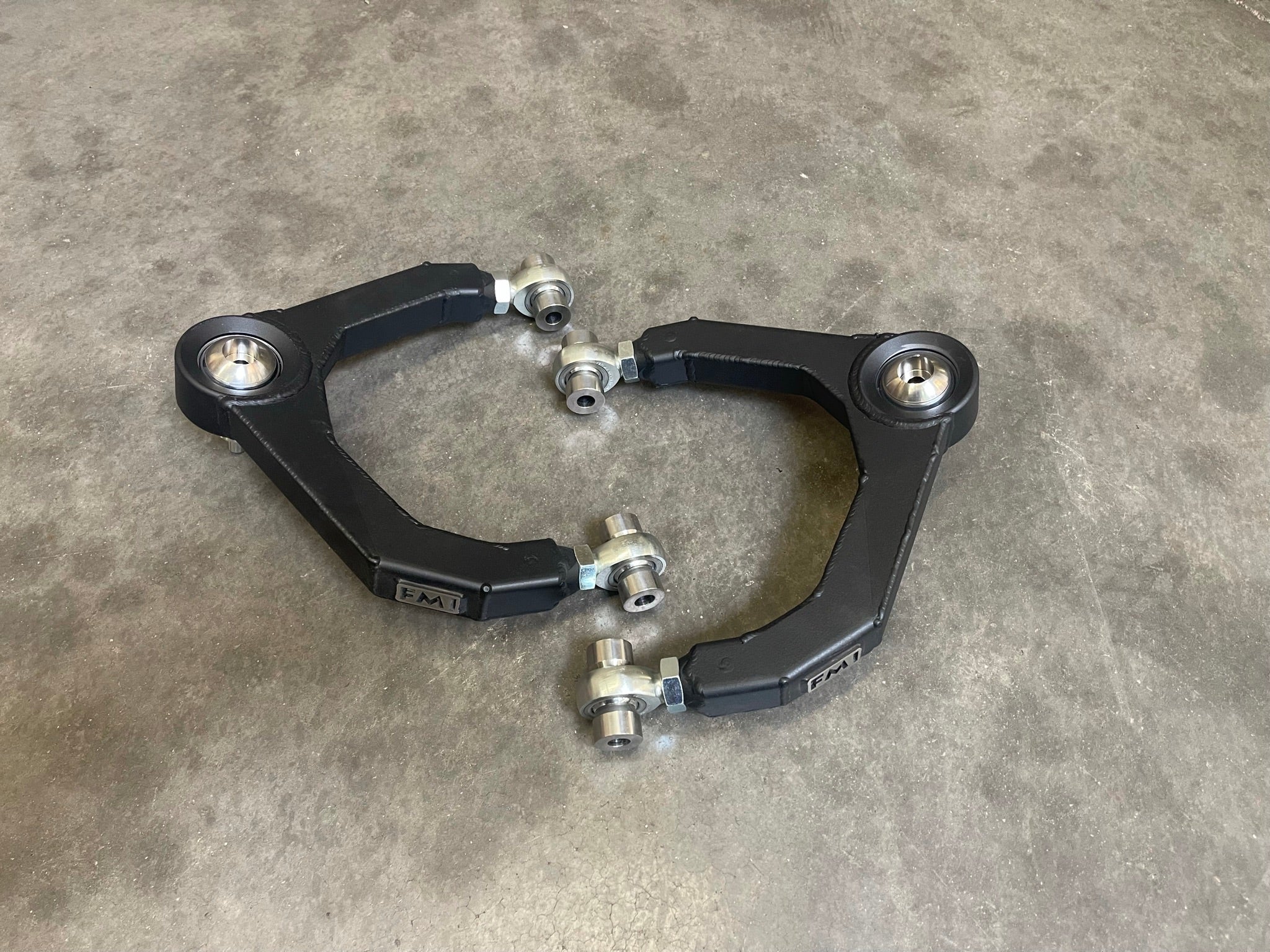 Fabricated upper arm kit for 2010-2014 Ford Raptor, designed for enhanced performance and durability in off-road conditions.