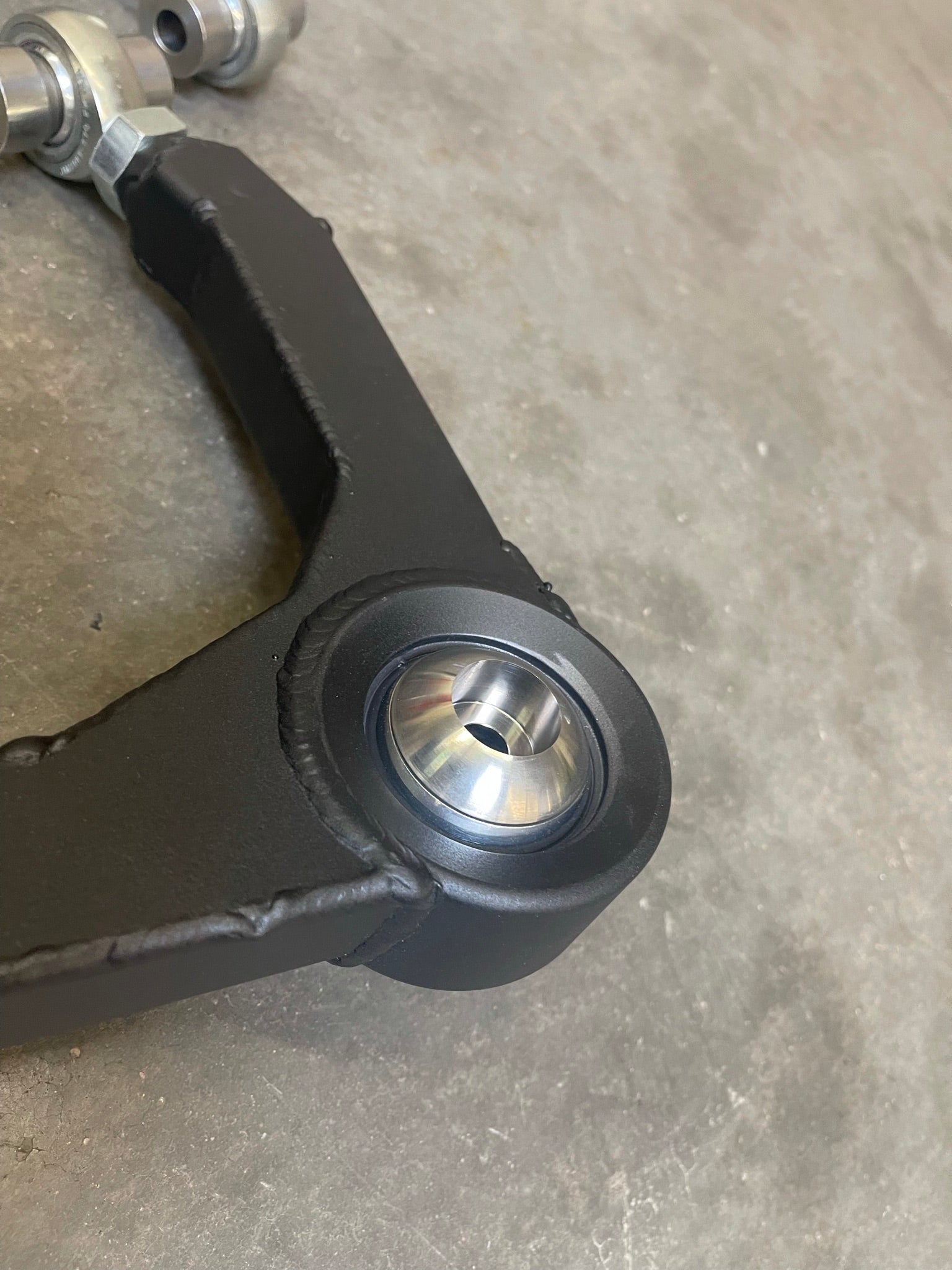 Close-up of a fabricated upper arm kit for 2017-2018 Gen 2 Raptor, showcasing its durable construction and precision components.