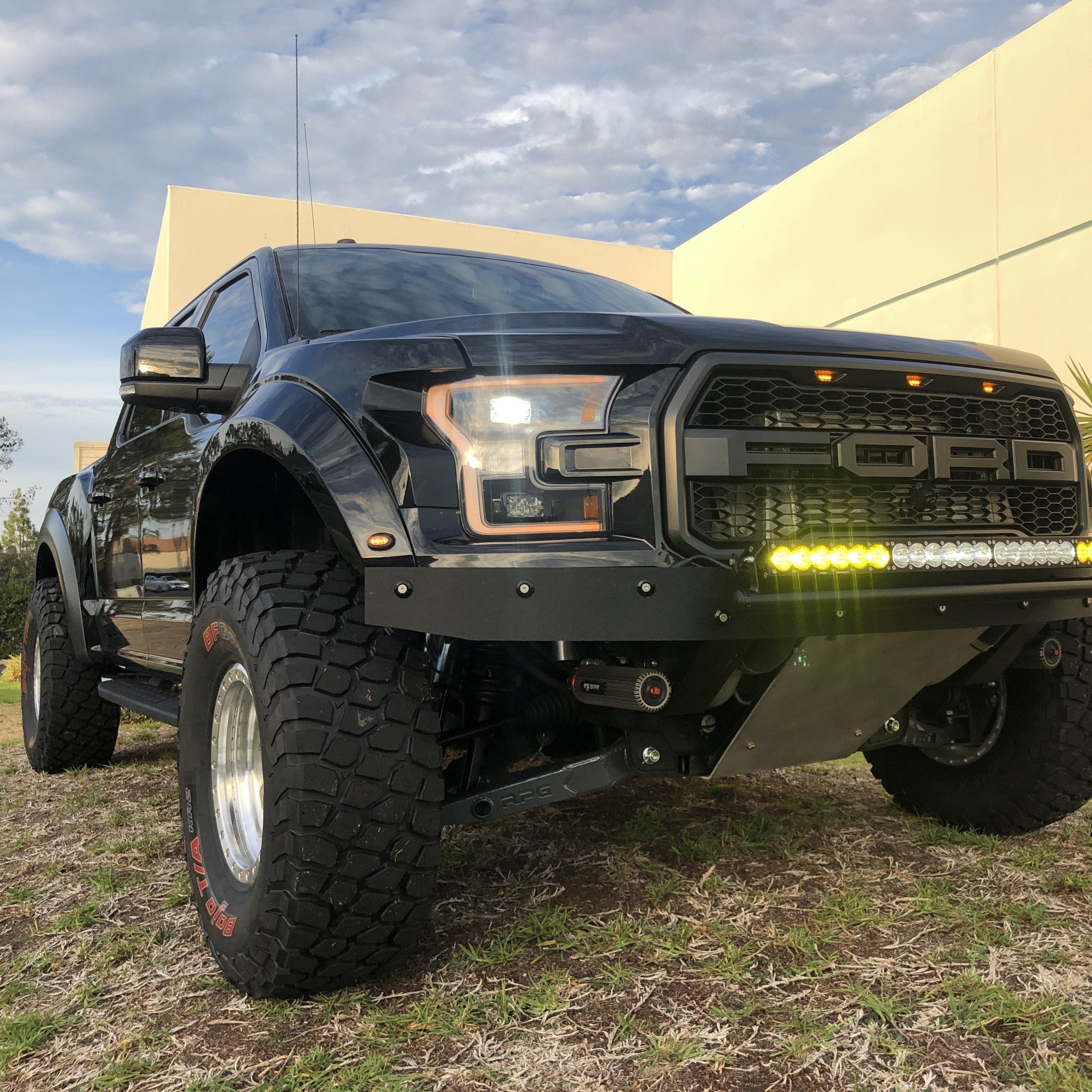 2017-2020 Ford Raptor with aftermarket fenders and offroad lights, showcasing rugged design and enhanced performance.