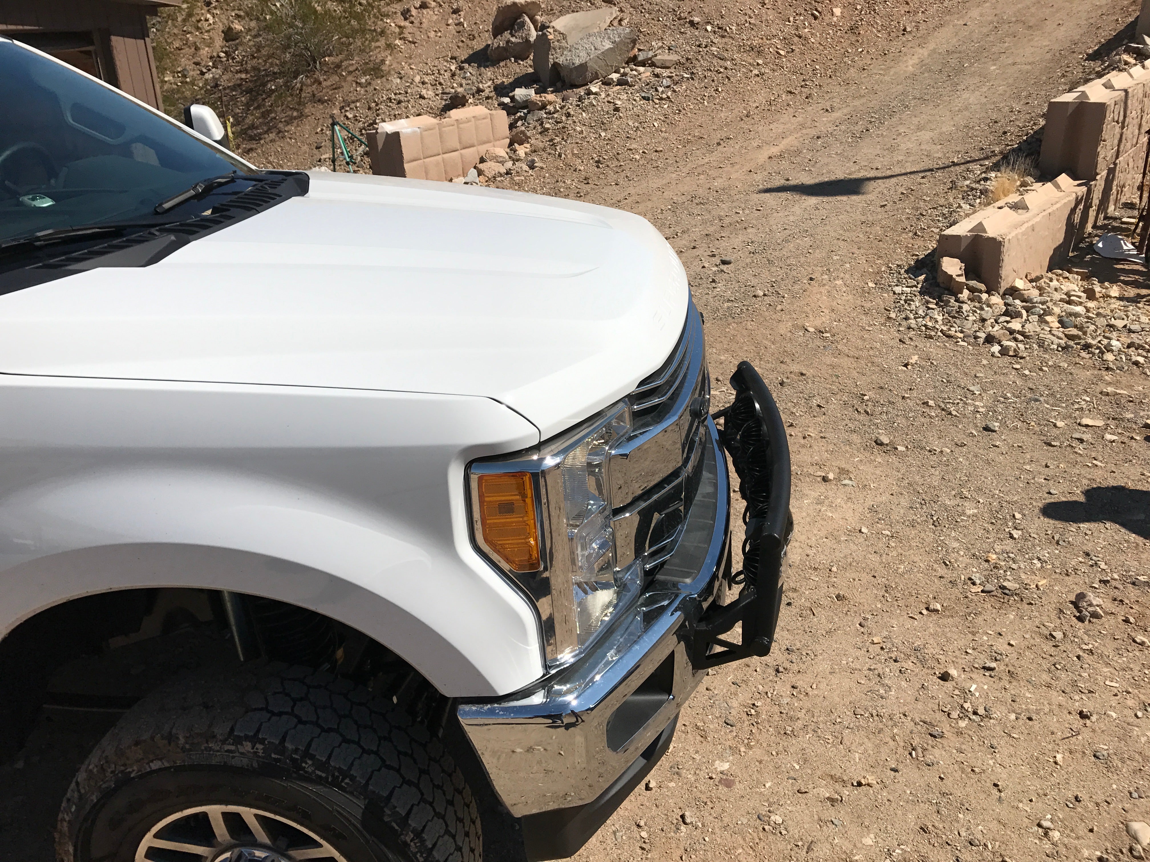 Light mount kit for 2017-2020 Ford Super Duty, designed for stock front bumper, showcased on a white truck.
