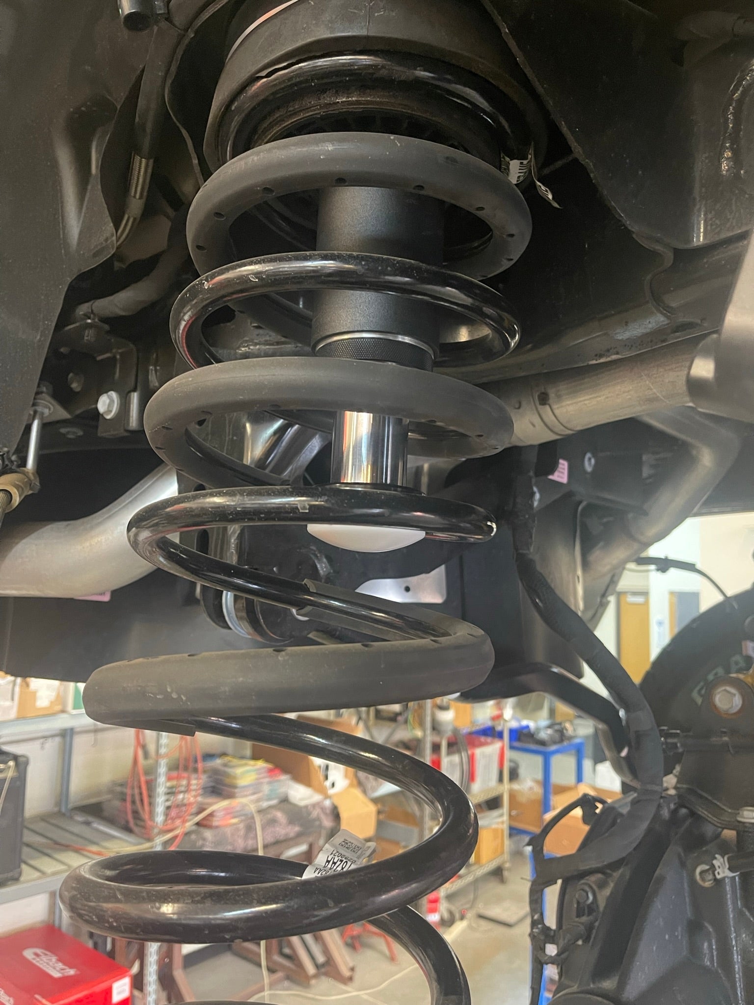 2025 Ram RHO Rear Hydraulic Bump Stop Kit installed, showcasing the spring and bump stop assembly for enhanced suspension performance.