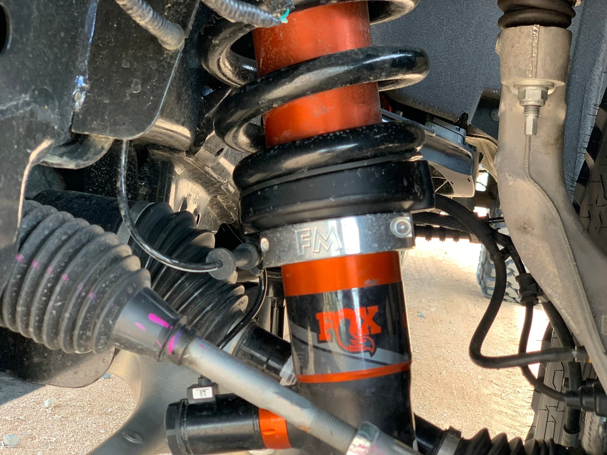 2021 and newer Raptor front leveling kit showcasing 2 inch or 1.5 inch lift with detailed shock and spring components.