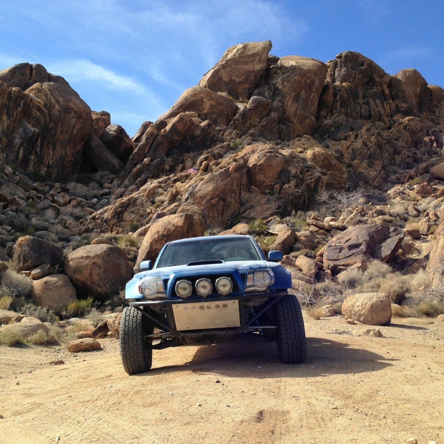 2005-2015 Toyota Tacoma fenders showcased on a modified truck in a rugged outdoor setting with rocky terrain.