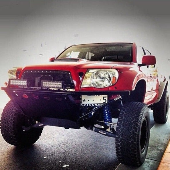 2005-2015 Toyota Tacoma fenders on a modified red truck with offroad tires and enhanced suspension.