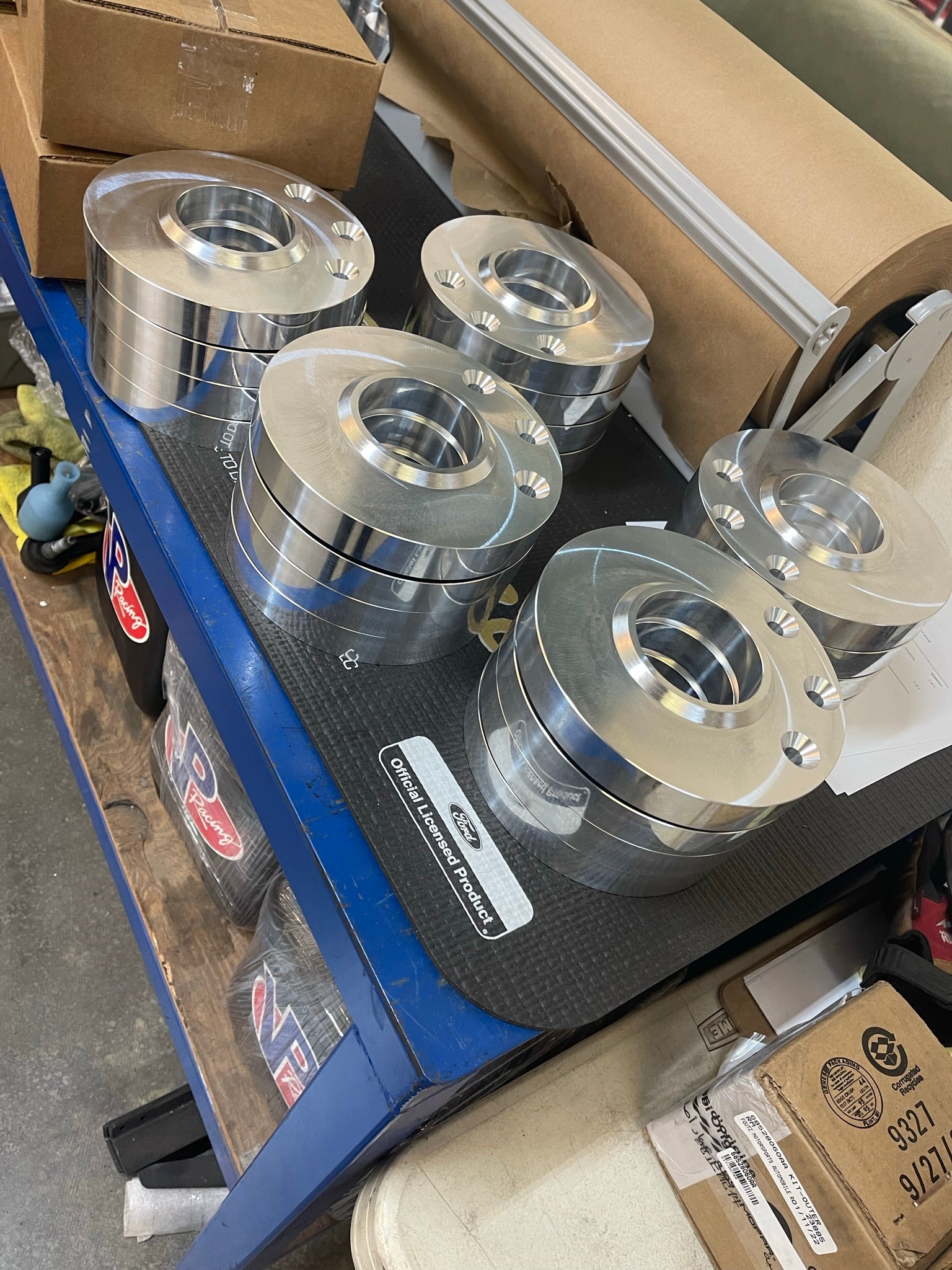 2021 and up Raptor rear spring 3/4 inch spacer lift kit by Foutz Motorsports displayed on a workbench.