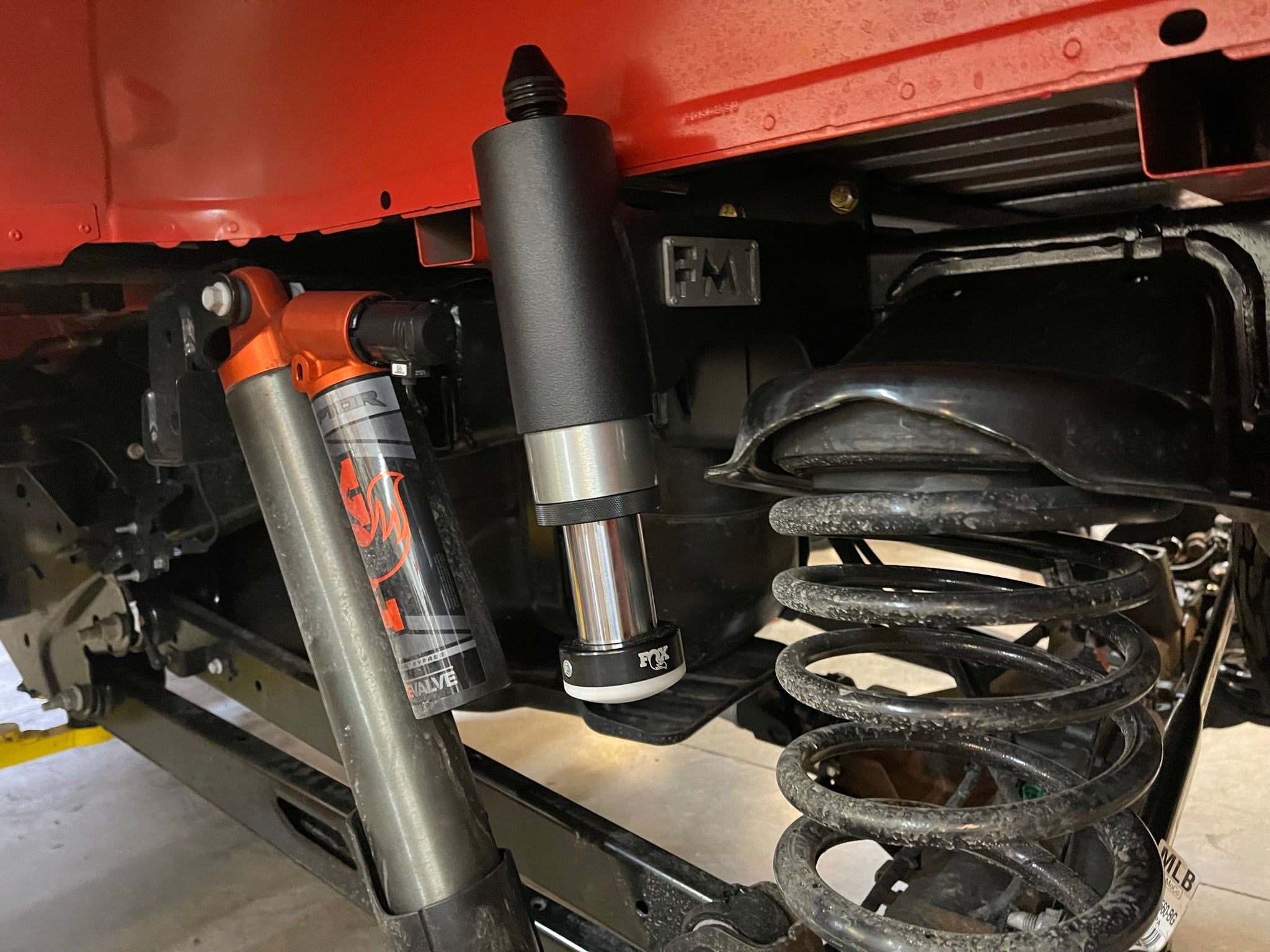 2021-2024 Ford Raptor rear bump stop kit installed, showcasing suspension components and shock absorber details.
