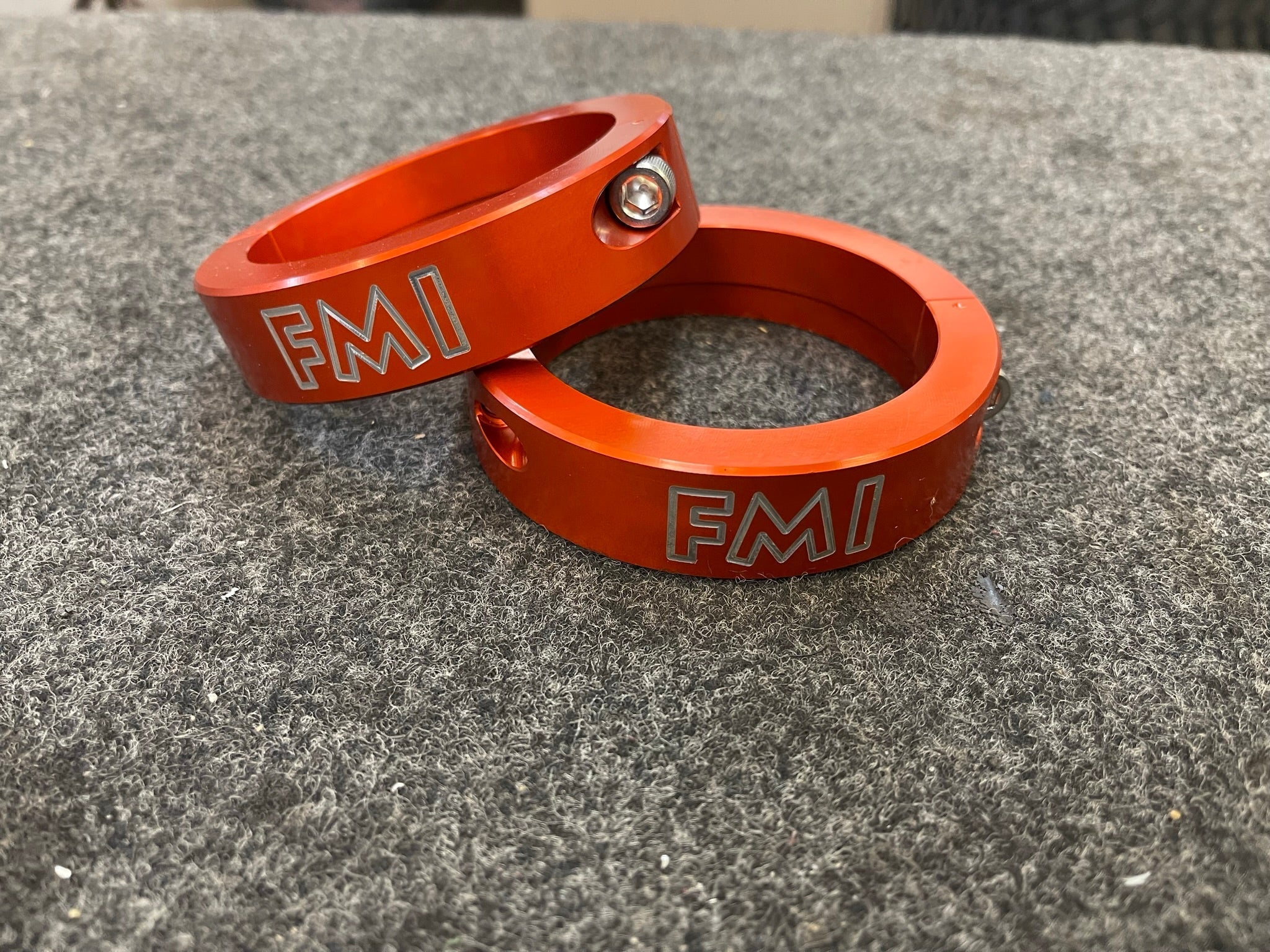 Front leveling kit for 2022 and newer Bronco Raptor featuring durable orange aluminum spacers with FMI branding.