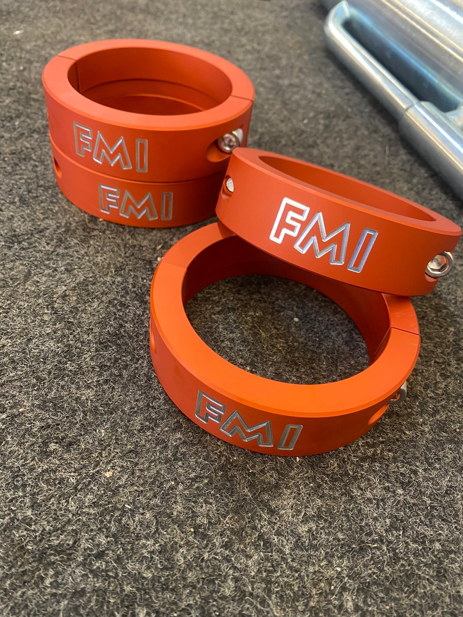 2021 and up Raptor front leveling kit featuring 2 inch and 1.5 inch lift spacers in durable orange aluminum.