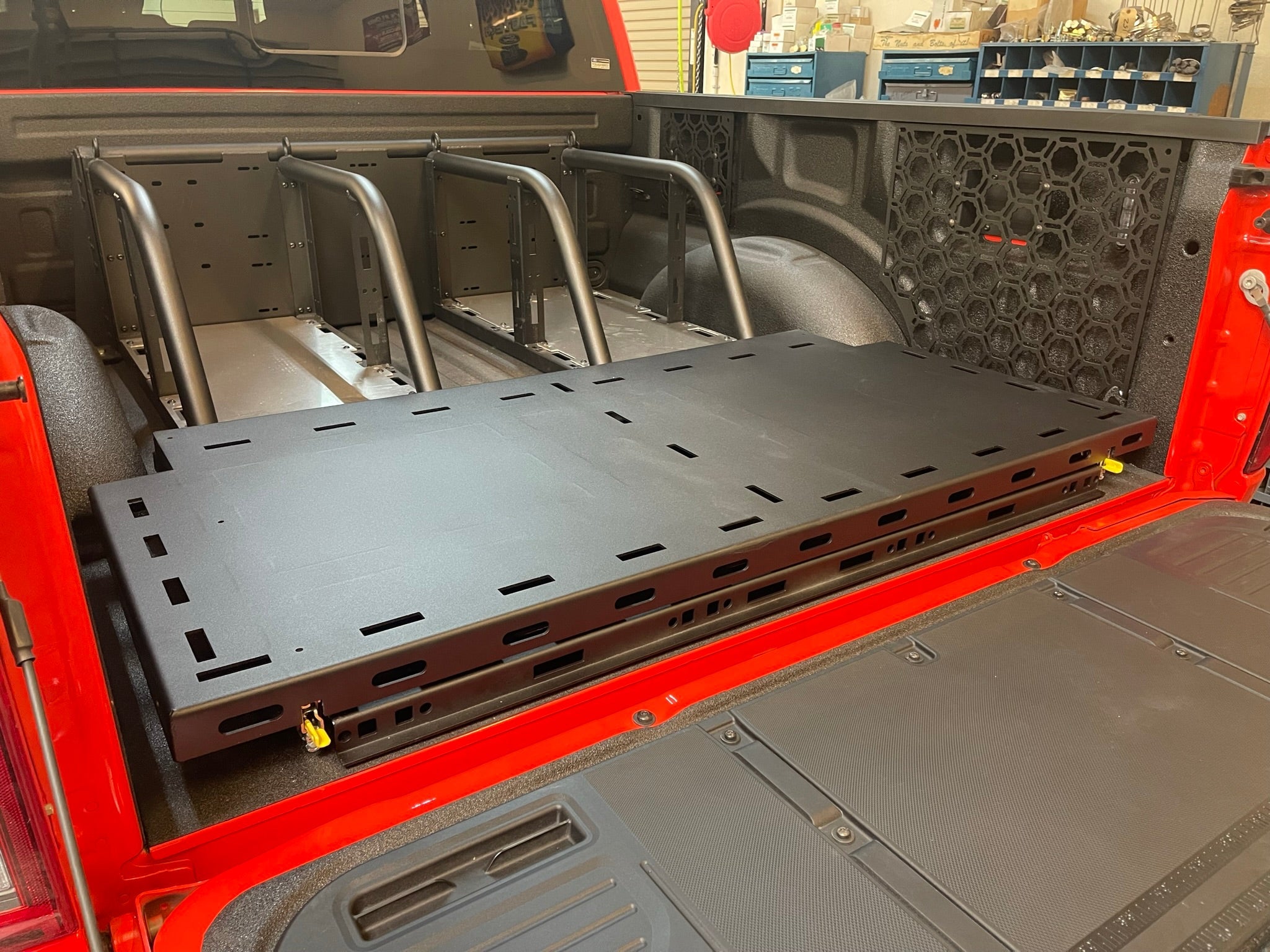 Modular bed organizer for 2017-2024 Ford Raptor featuring a slide-out cargo tray for enhanced storage and accessibility.