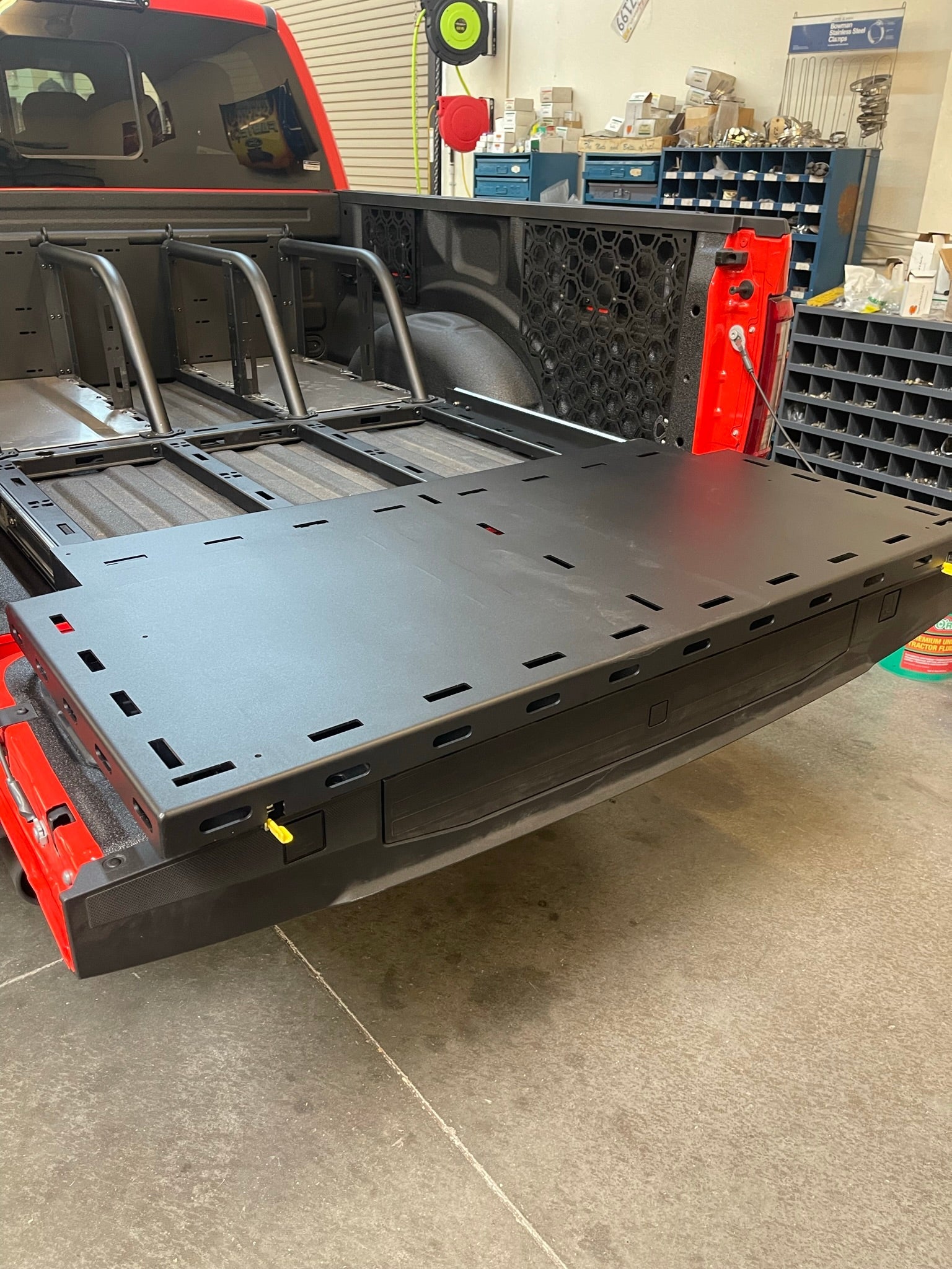 Modular bed organizer for 2017-2024 Ford Raptor featuring a slide-out cargo tray for enhanced storage and accessibility.