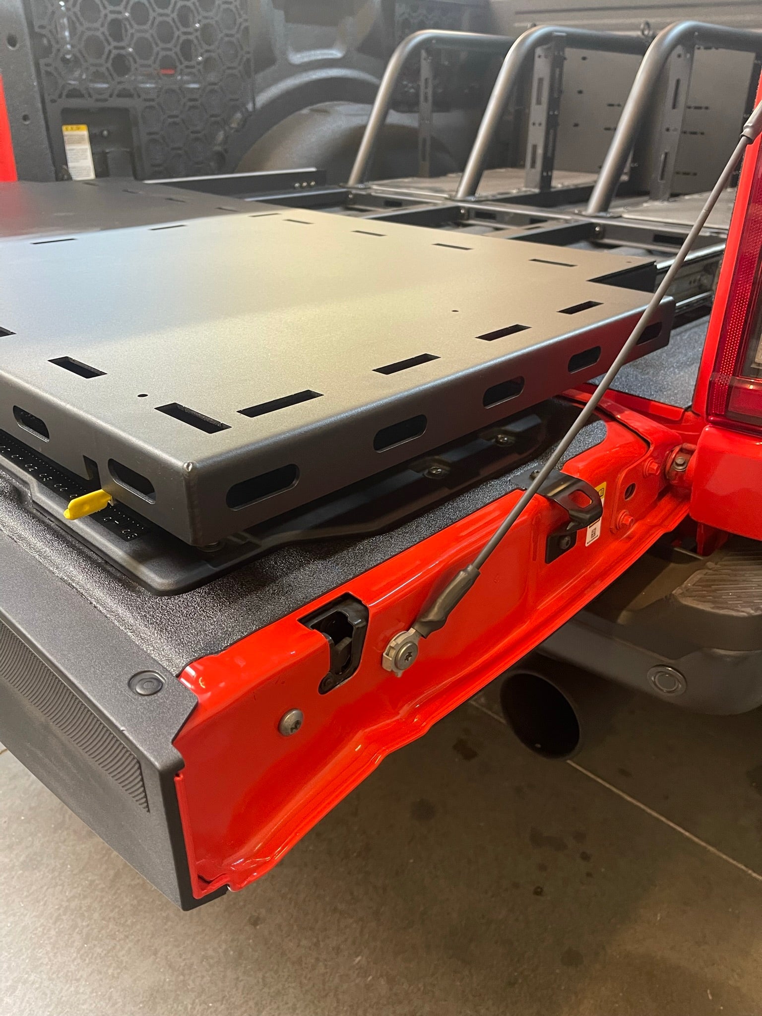 Modular bed organizer for 2017-2024 Ford Raptor featuring a slide-out cargo tray for easy access and storage.