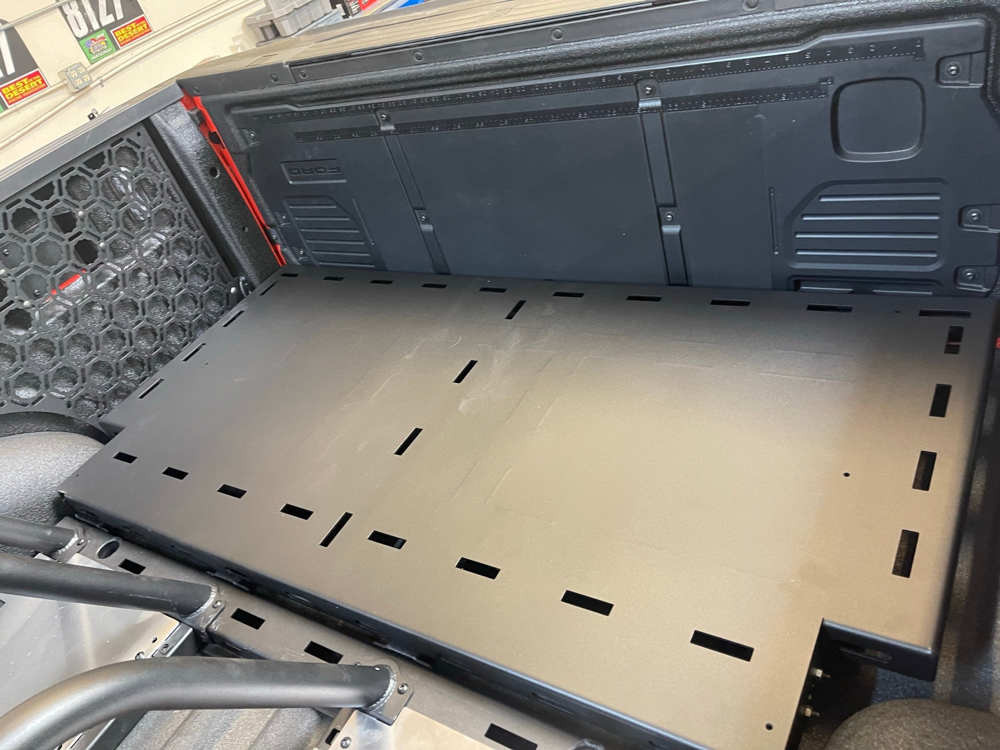 Modular bed organizer for 2017-2024 Ford Raptor featuring a slide-out cargo tray for efficient storage and access.