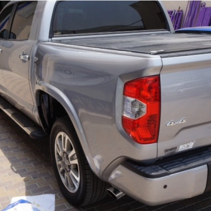 2014-2021 Toyota Tundra bedsides showcasing a silver truck with a sleek design and a covered bed.