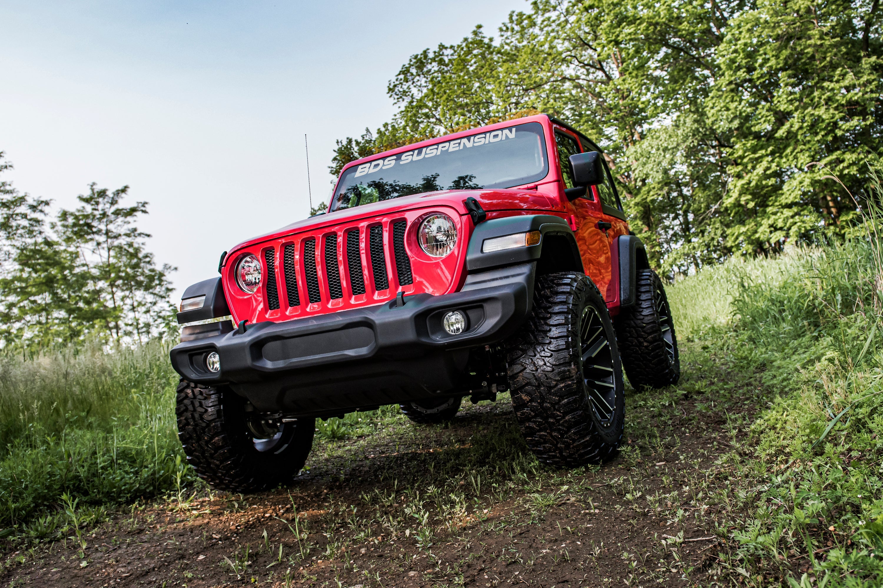 3-inch lift kit for Jeep Wrangler JL 2-Door (2018-2025) showcased on a modified red Jeep with off-road tires.