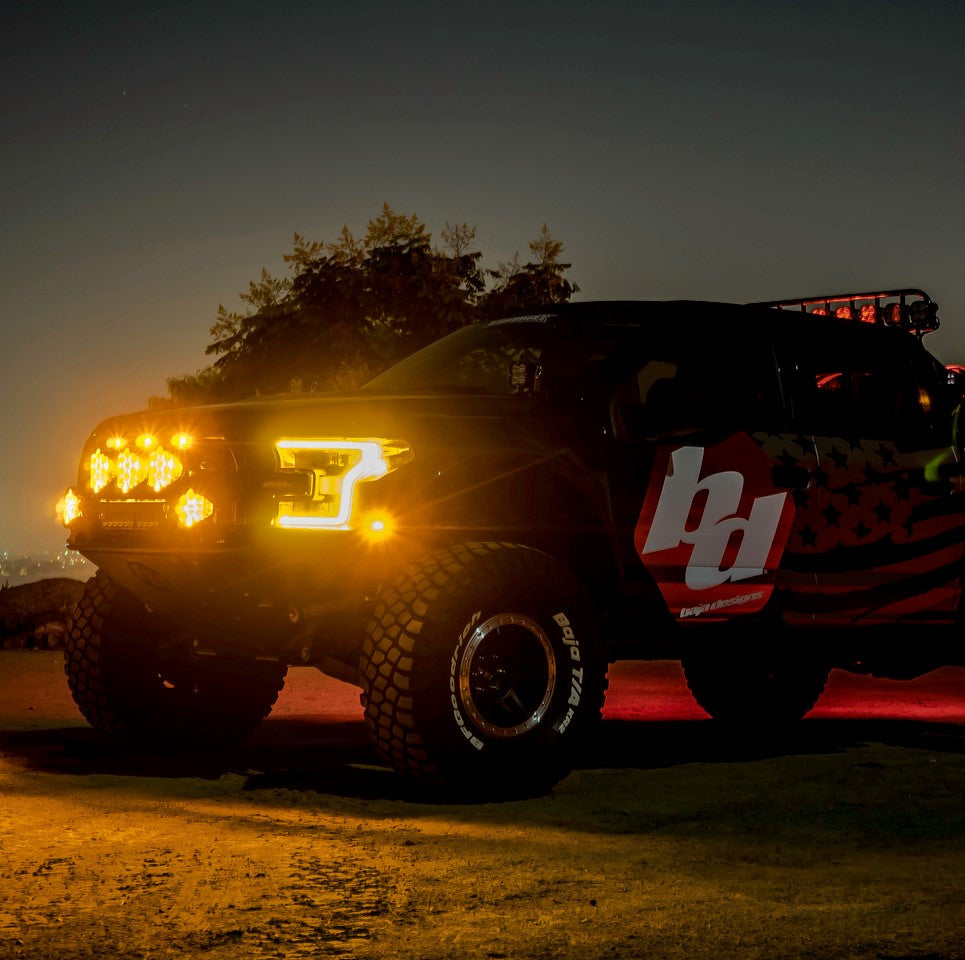 Baja Designs LP6 Pro LED spot lights mounted on a truck, illuminating the night with a powerful beam.