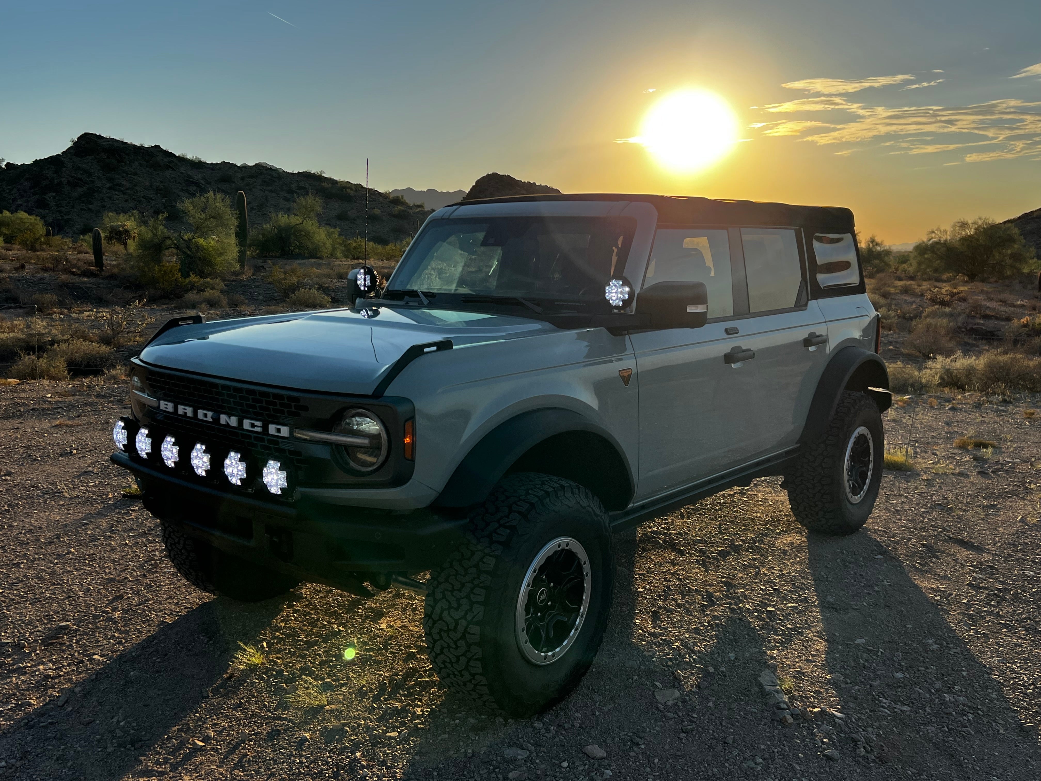 2022-UP Bronco Raptor Front Light Mount Kit installed on a Bronco in a desert setting, showcasing offroad capabilities.