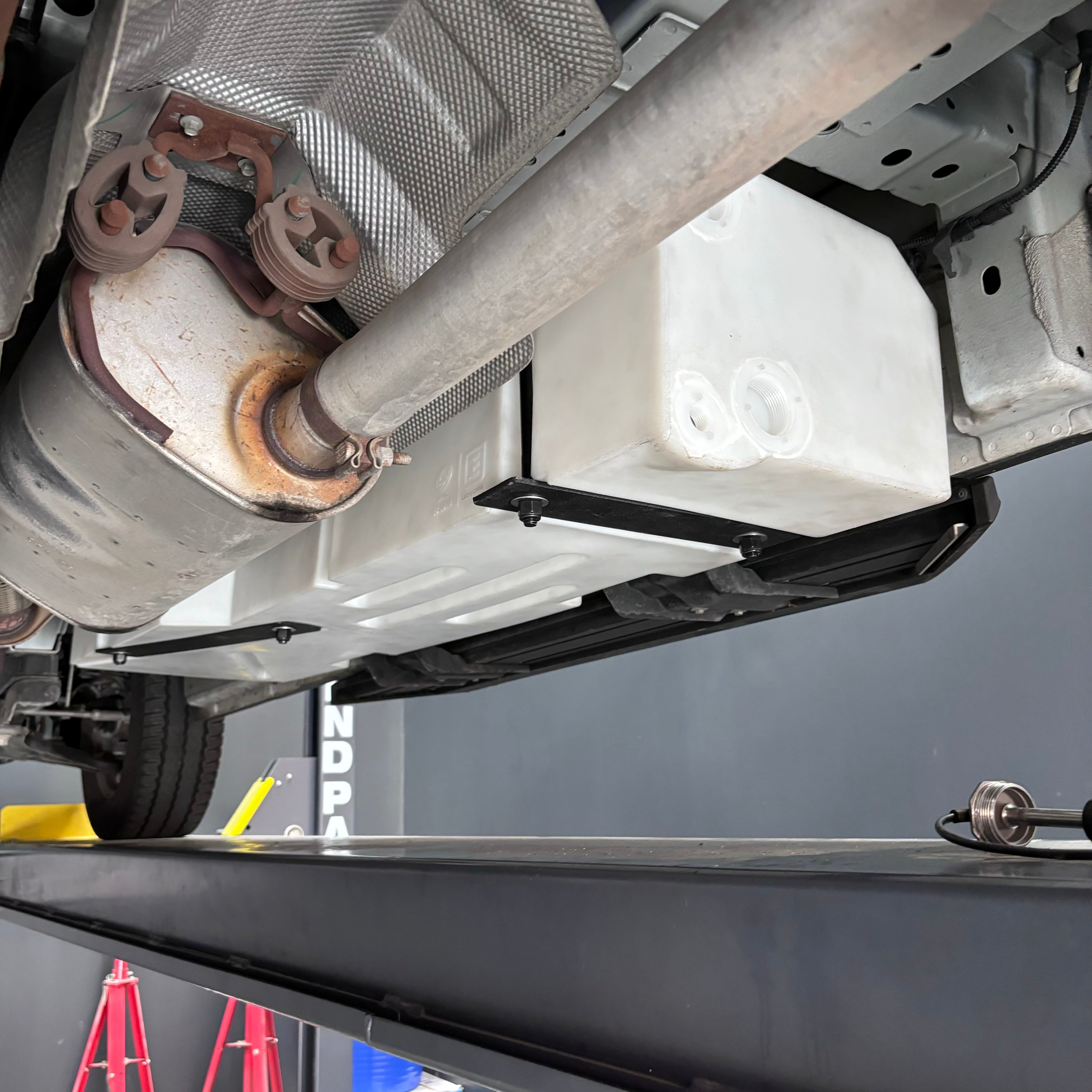 20-gallon undercarriage fresh/grey water tank installed on a 2015-2025 Ford Transit, showcasing its durable design and fit.