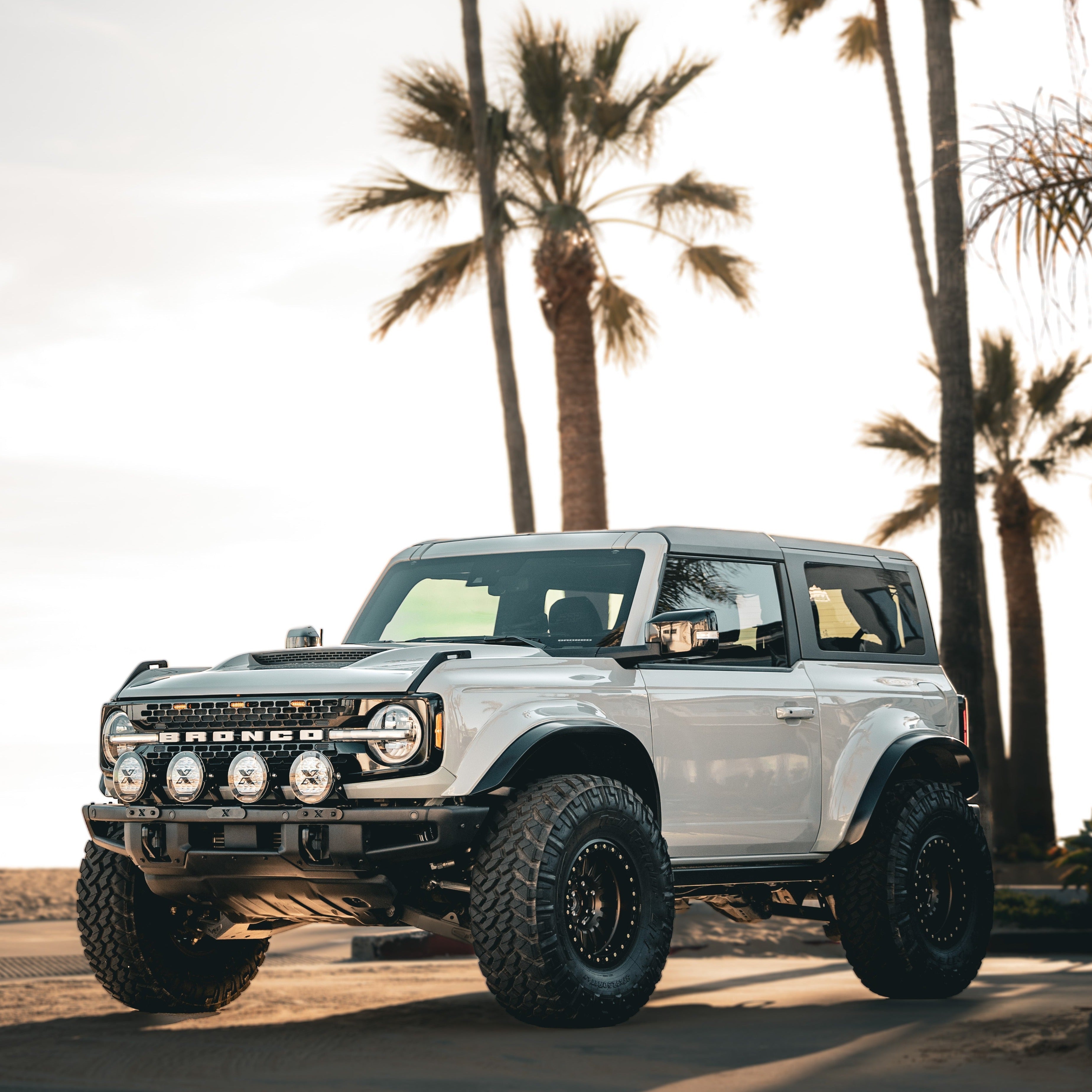 2021-2025 Ford Bronco with a Ram Air Hood, showcasing offroad capabilities and rugged design against a palm tree backdrop.