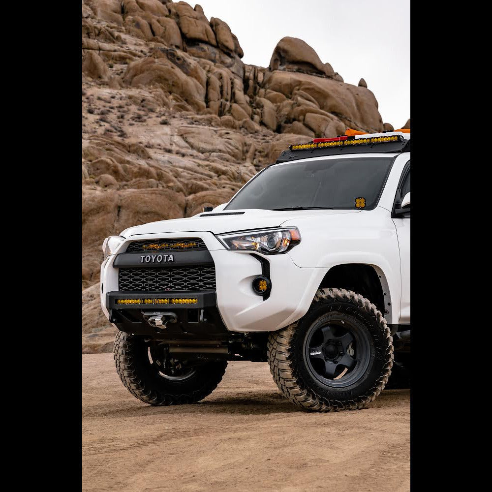 4Runner Lo-Pro Winch Bumper for 5th Gen models, 2014-2024, showcased on a modified white SUV in a rugged outdoor setting.