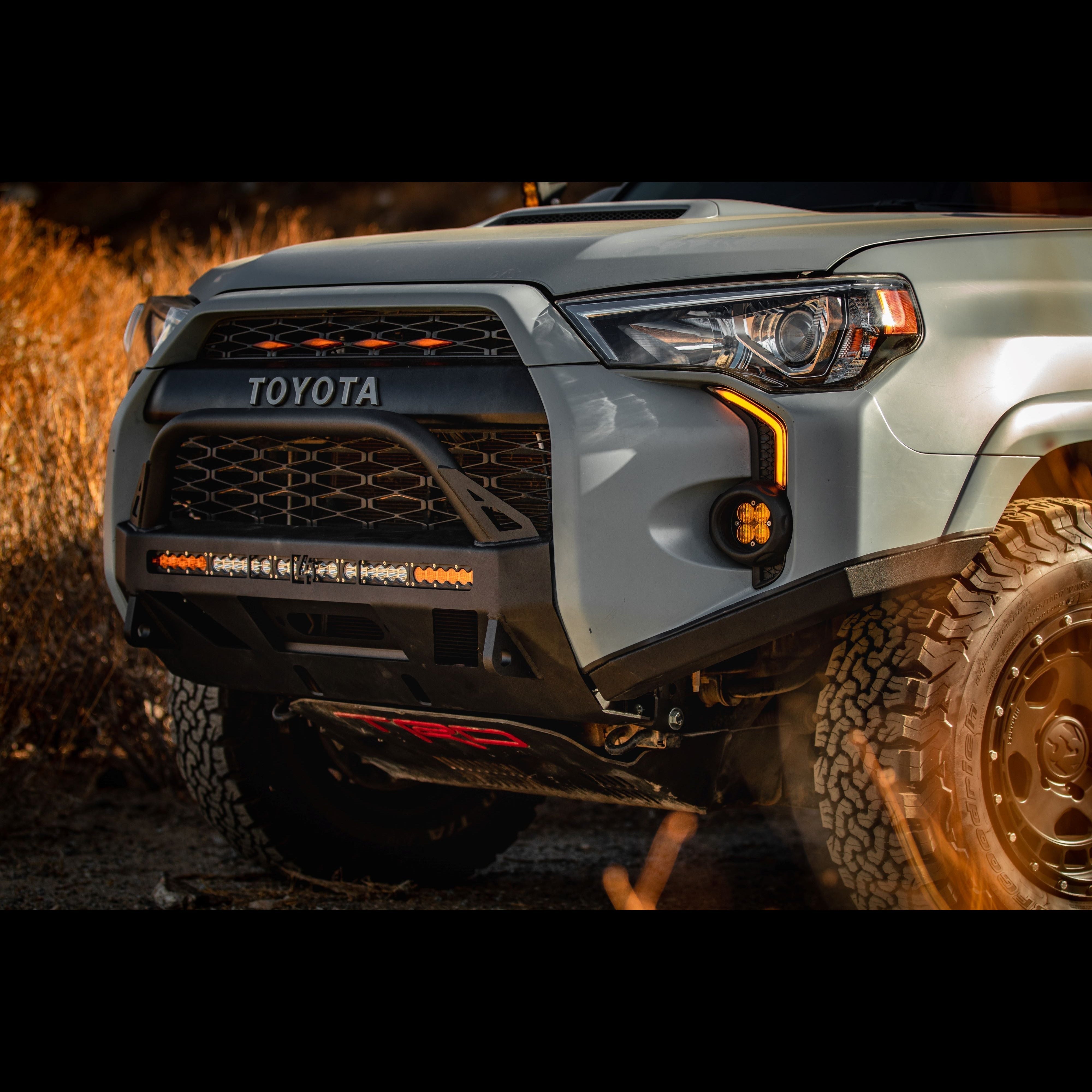 Lo-Pro winch bumper for 2014-2024 5th Gen Toyota 4Runner, featuring rugged design and integrated lighting for offroad use.