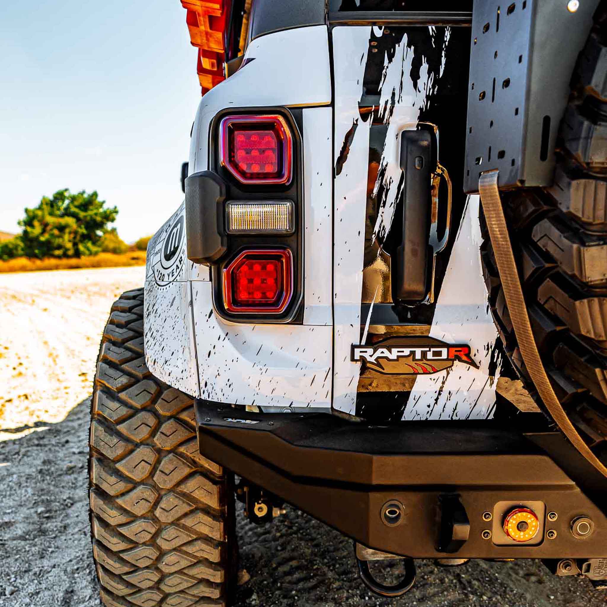Rear view of a 2022-2025 Ford Bronco Raptor showcasing the rear quarter kit with rugged design and off-road features.