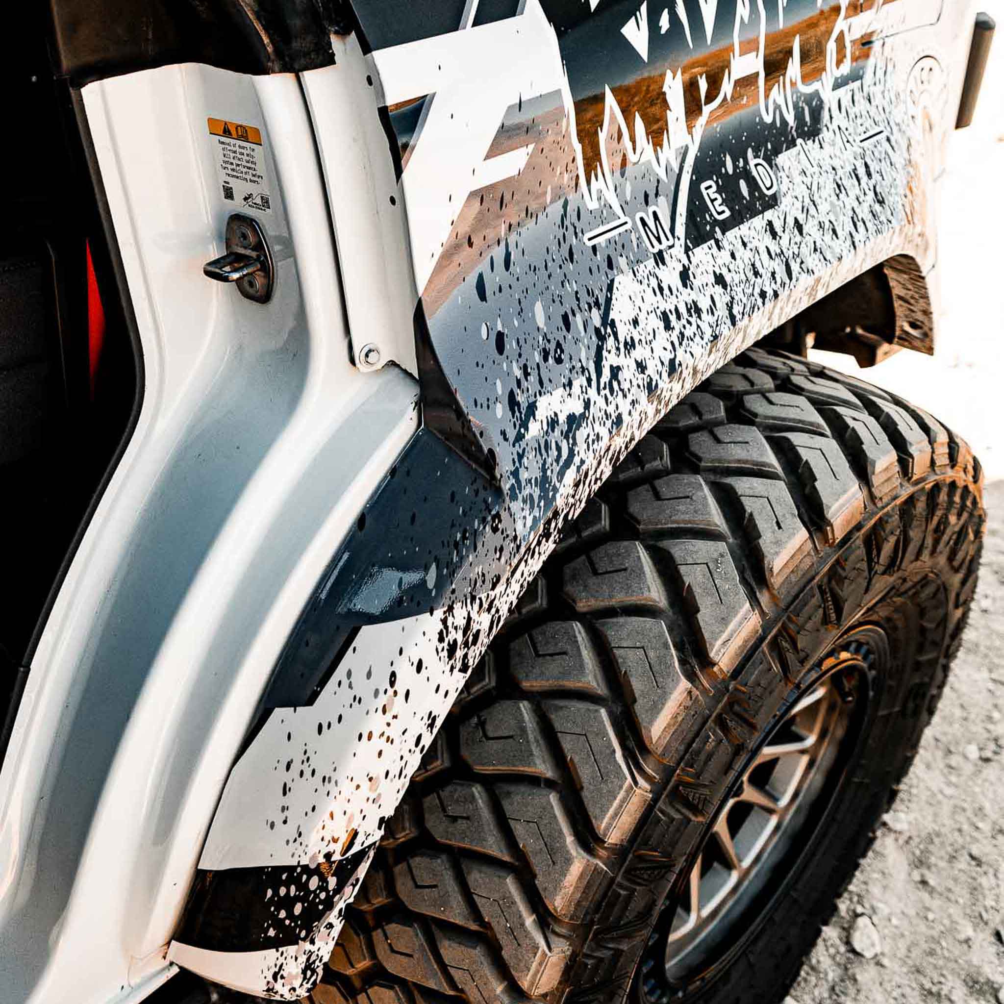 Close-up of a 2022-2025 Ford Bronco Raptor rear quarter kit showcasing rugged design and tire details.