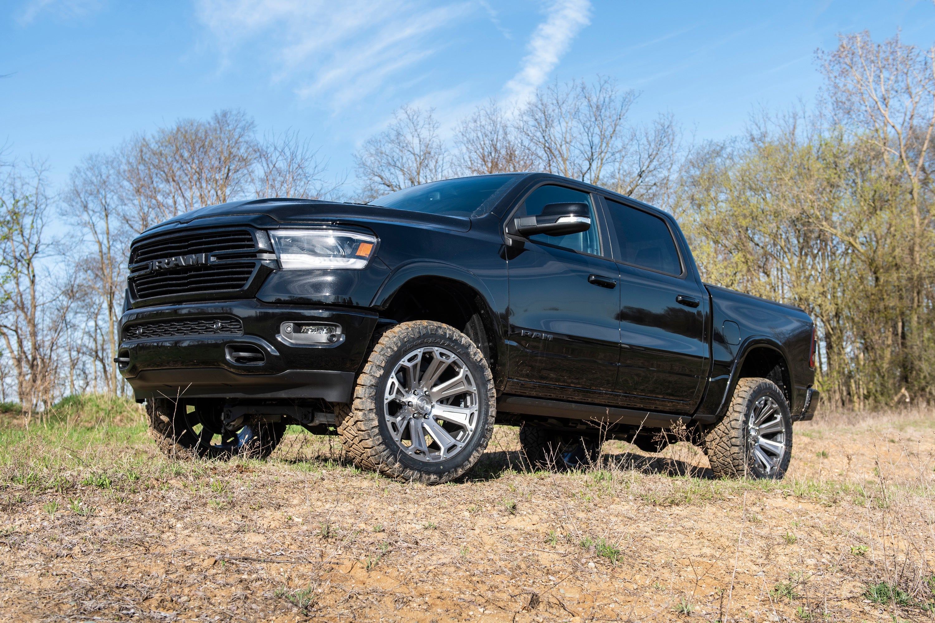 4-inch lift kit installed on a black Ram 1500 4WD, showcasing enhanced off-road capability and performance.