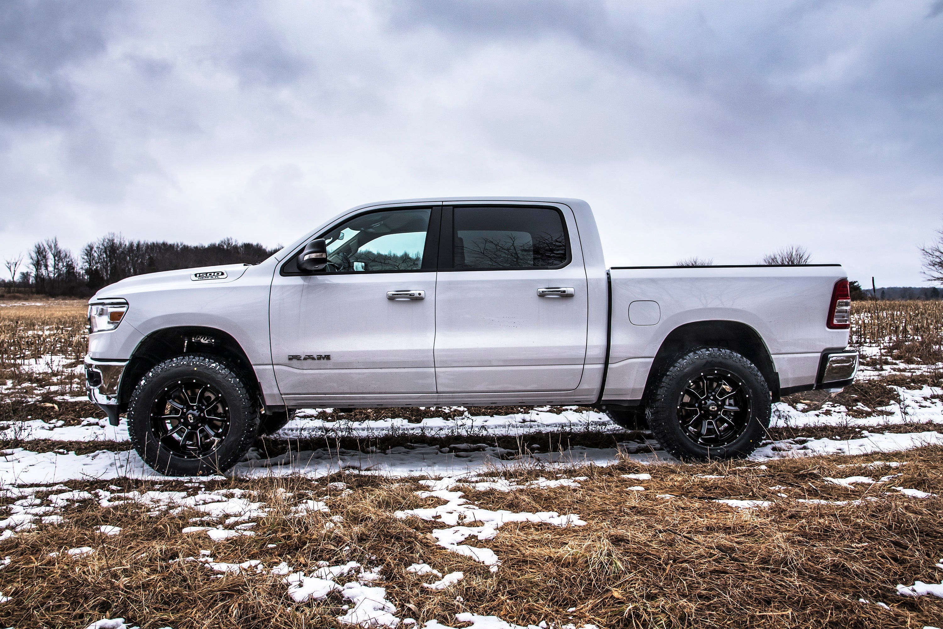 3-inch lift kit with FOX 2.5 Performance Elite Coil-Over installed on a lifted Ram 1500 4WD in a snowy field.