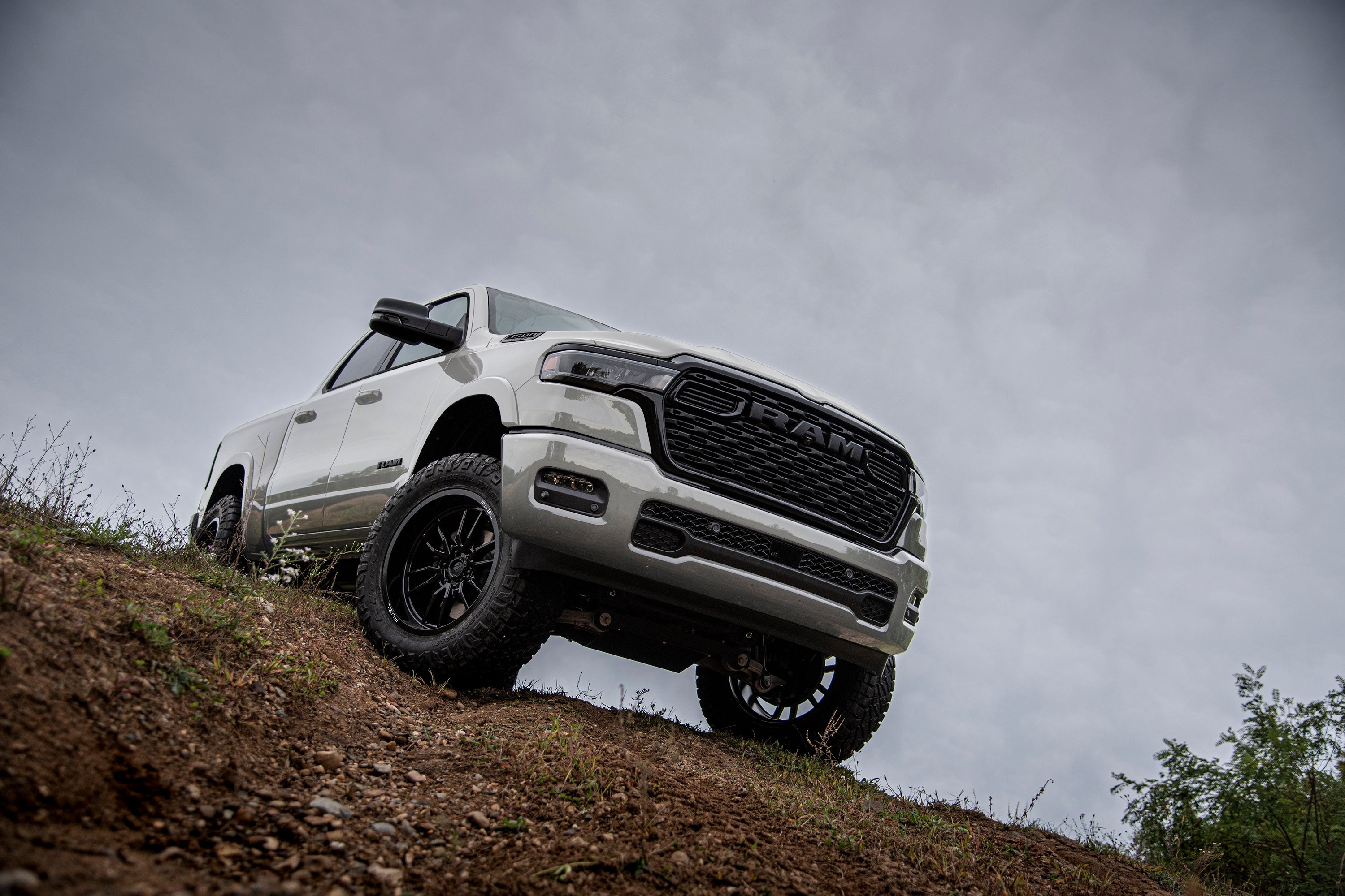 5-inch lift kit installed on a Ram 1500 Rebel, showcasing FOX 2.5 Performance Elite Coil-Over suspension on rugged terrain.