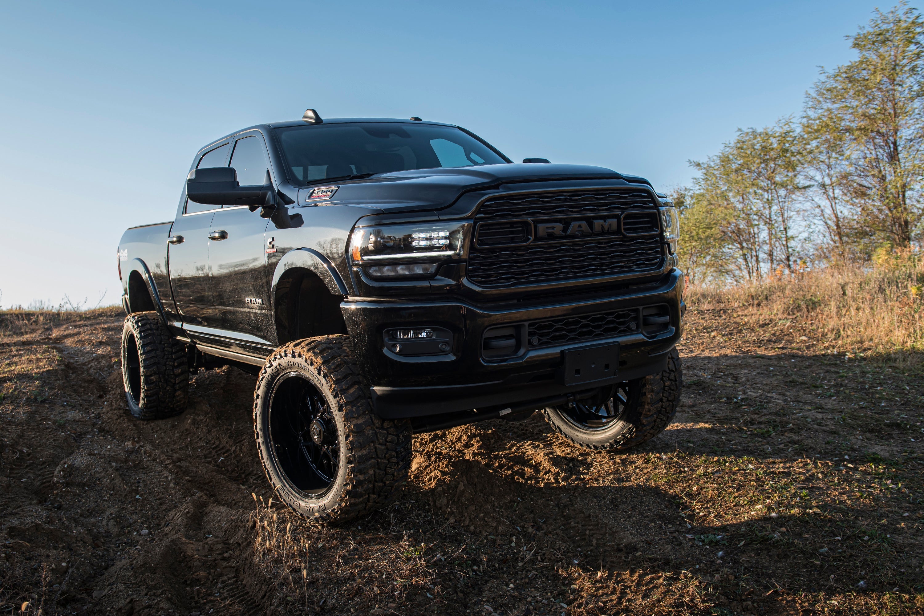 8-inch lift kit with 4-link installed on a black Ram 3500 4WD diesel truck, showcasing enhanced off-road capability.