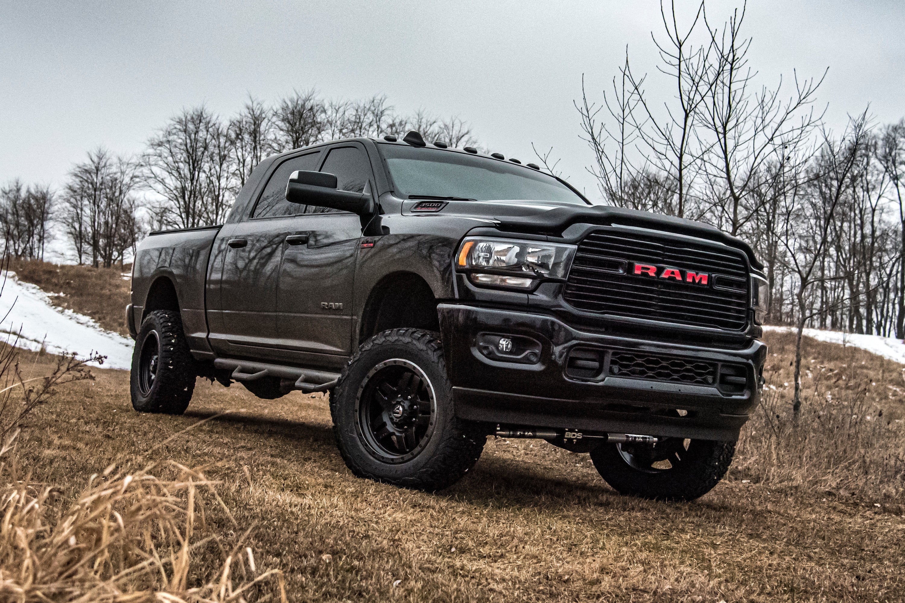 4-inch lift kit with radius arm and 3-inch rear block installed on a 2019-2024 Ram 3500 4WD diesel truck in an outdoor setting.