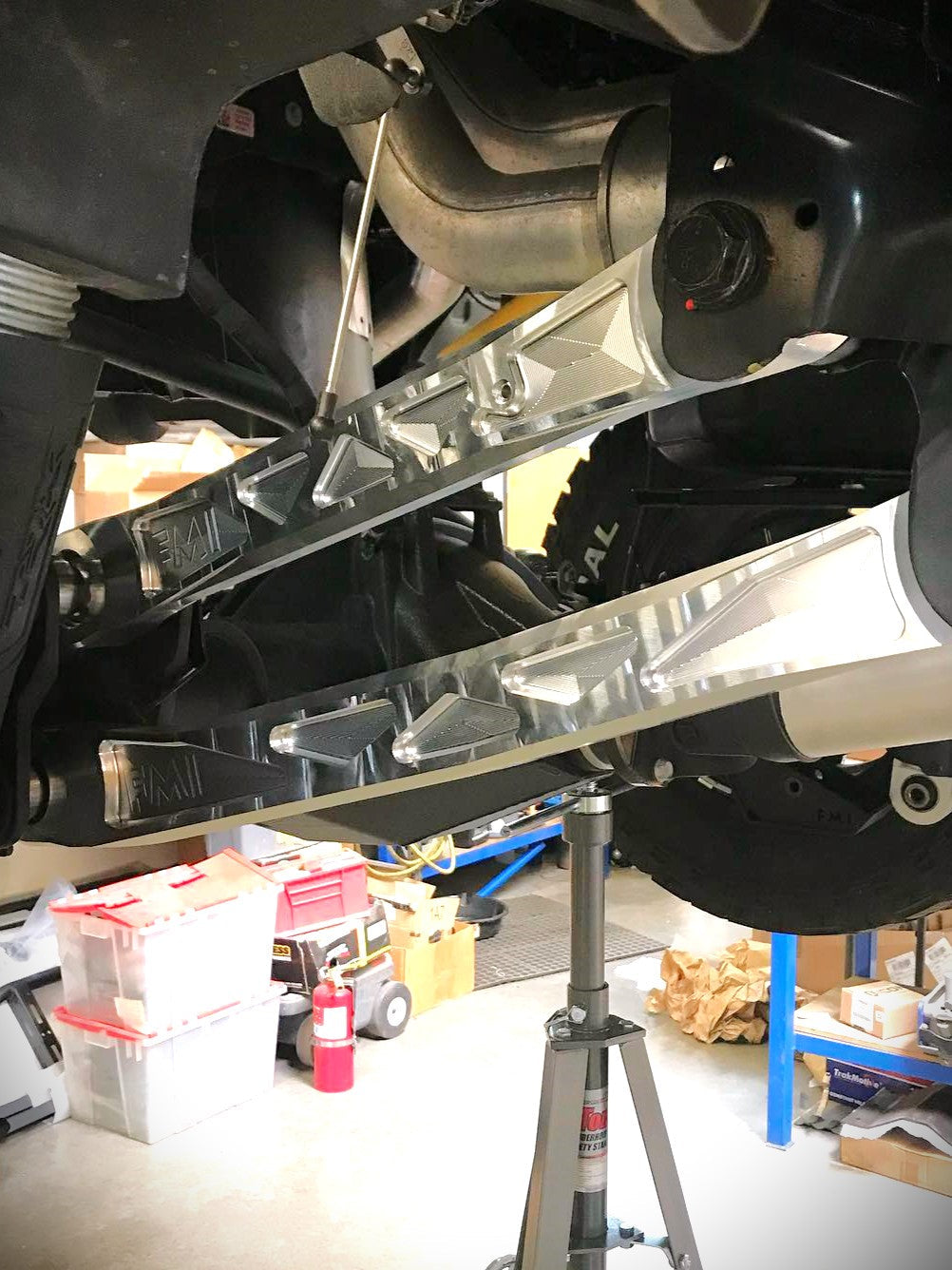 2025 Ram RHO rear suspension arm kit made of billet aluminum, showcasing its installation under a truck.