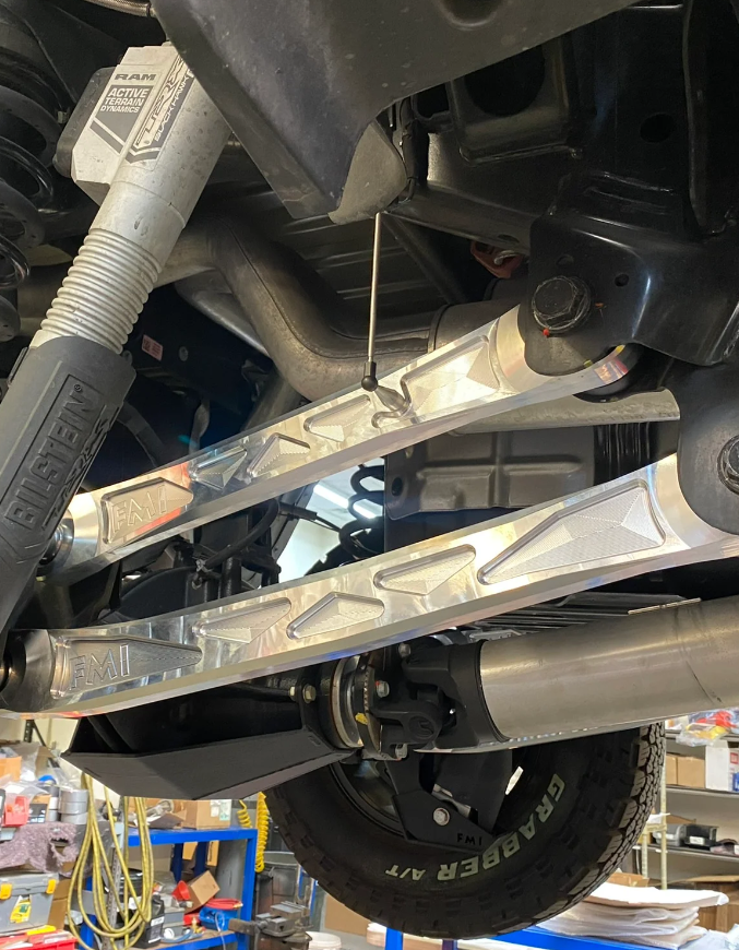 2025 Ram RHO rear upper suspension arm kit made of billet aluminum, showcasing its durable design and installation in a vehicle.