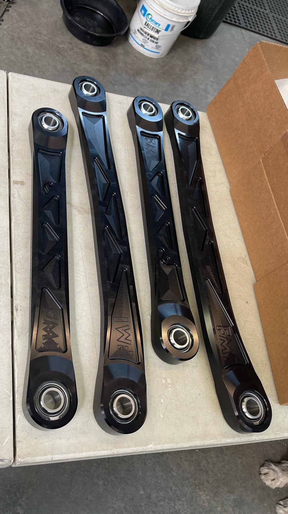 2025 Ram RHO rear upper suspension arm kit made of billet aluminum, featuring four sleek black arms with precision design.