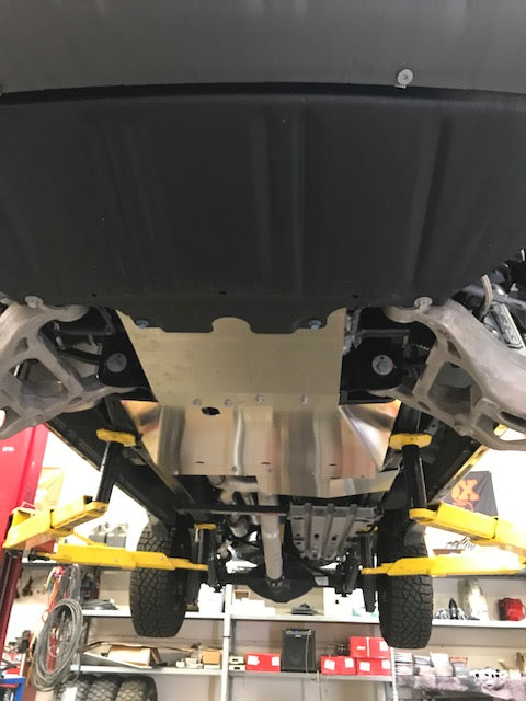 Underbody view of a 2021-2024 Ram TRX with a skid plate kit installed, showcasing durable protection and installation setup.