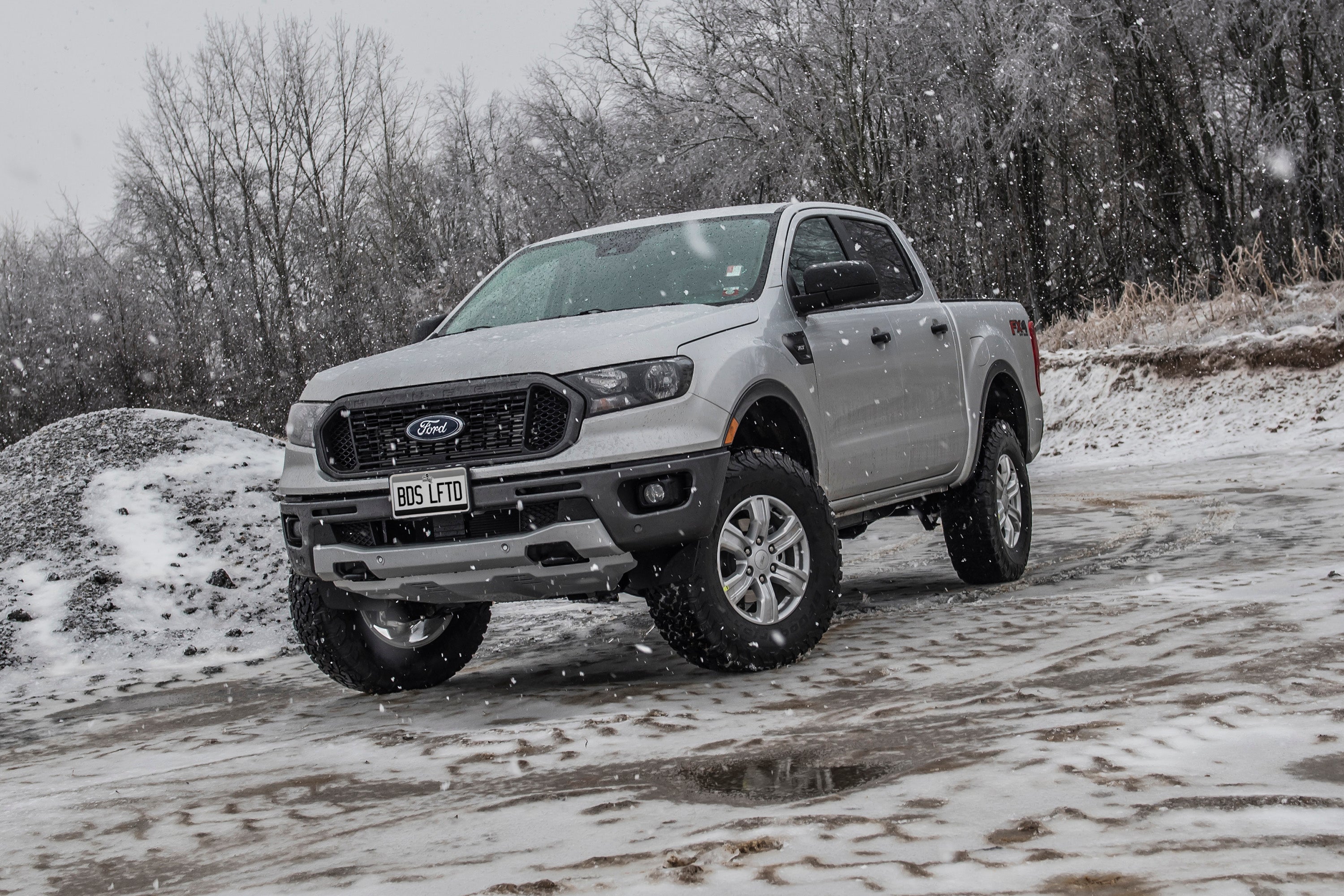 2.5 inch leveling kit installed on a Ford Ranger 4WD, showcasing enhanced height and rugged design in snowy terrain.