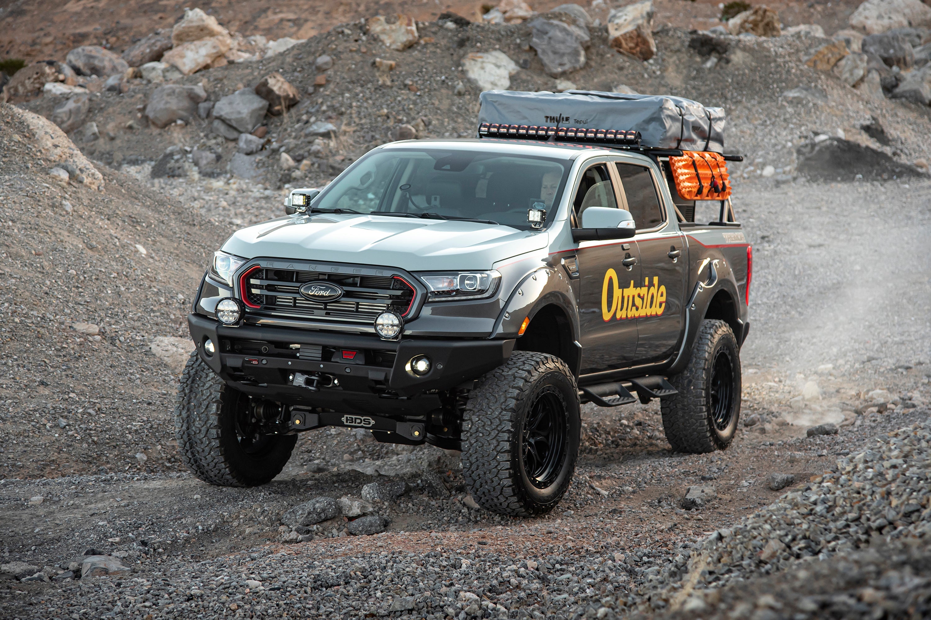 Ford Ranger with a 6-inch lift kit and FOX 2.5 coil-over suspension, showcasing off-road capability in rugged terrain.