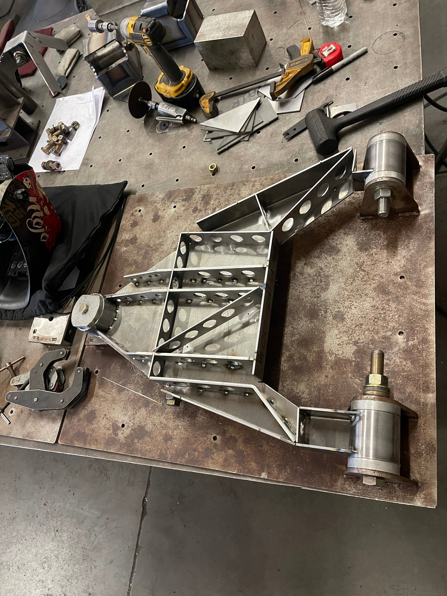 2017 Up Raptor Long Travel Front Suspension Kit - Gen 2 displayed on a workbench with tools and materials in the background.