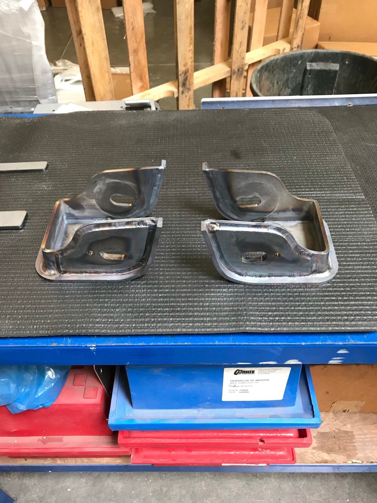 Lower arm pocket replacement kit for 2017-2024 Raptor by Foutz Motorsports, showcasing durable metal components on a workbench.