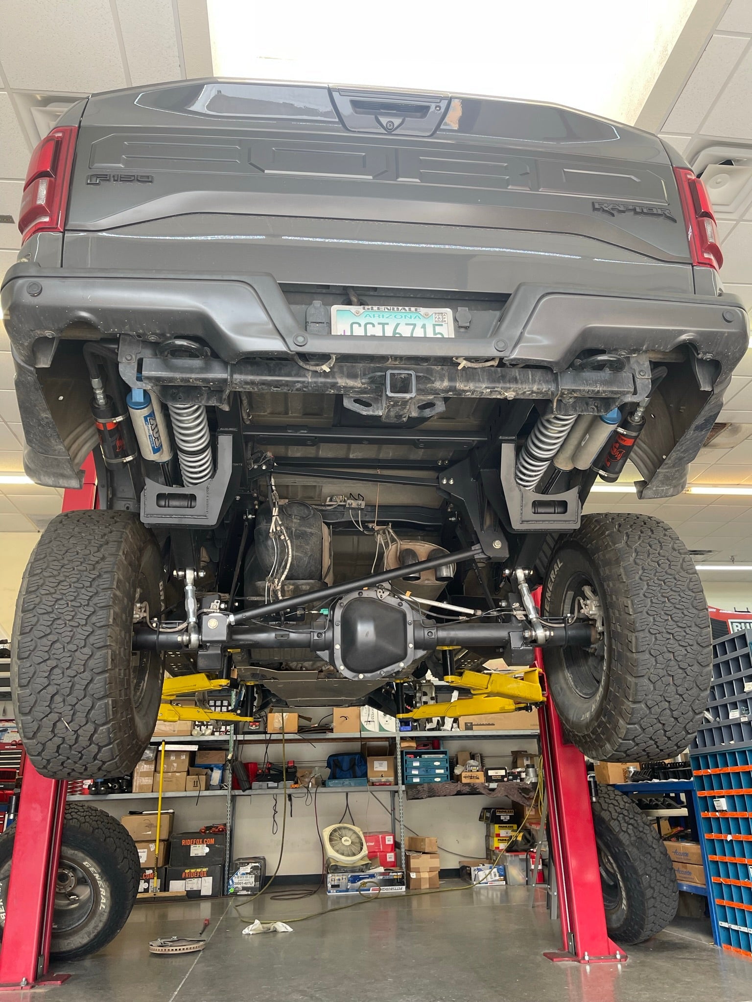 2021-2024 Raptor Long Travel Rear Suspension Kit installed, showcasing 19 inches of travel in a workshop setting.