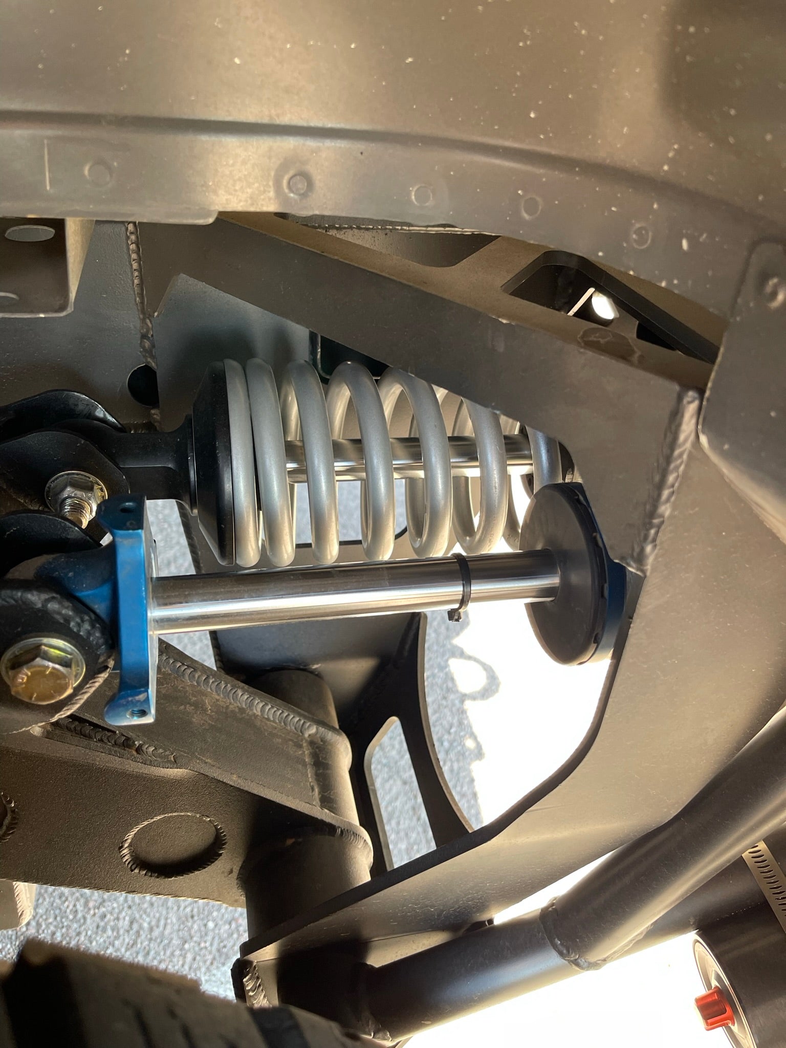 Long travel 5-link rear suspension conversion kit for 2010-2014 F150 and Gen 1 Raptors, showcasing a shock absorber and coil spring.