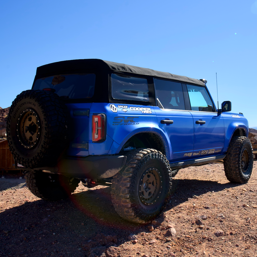 2021-2025 Ford Bronco with aftermarket fenders, showcasing rugged off-road capabilities in a desert setting.