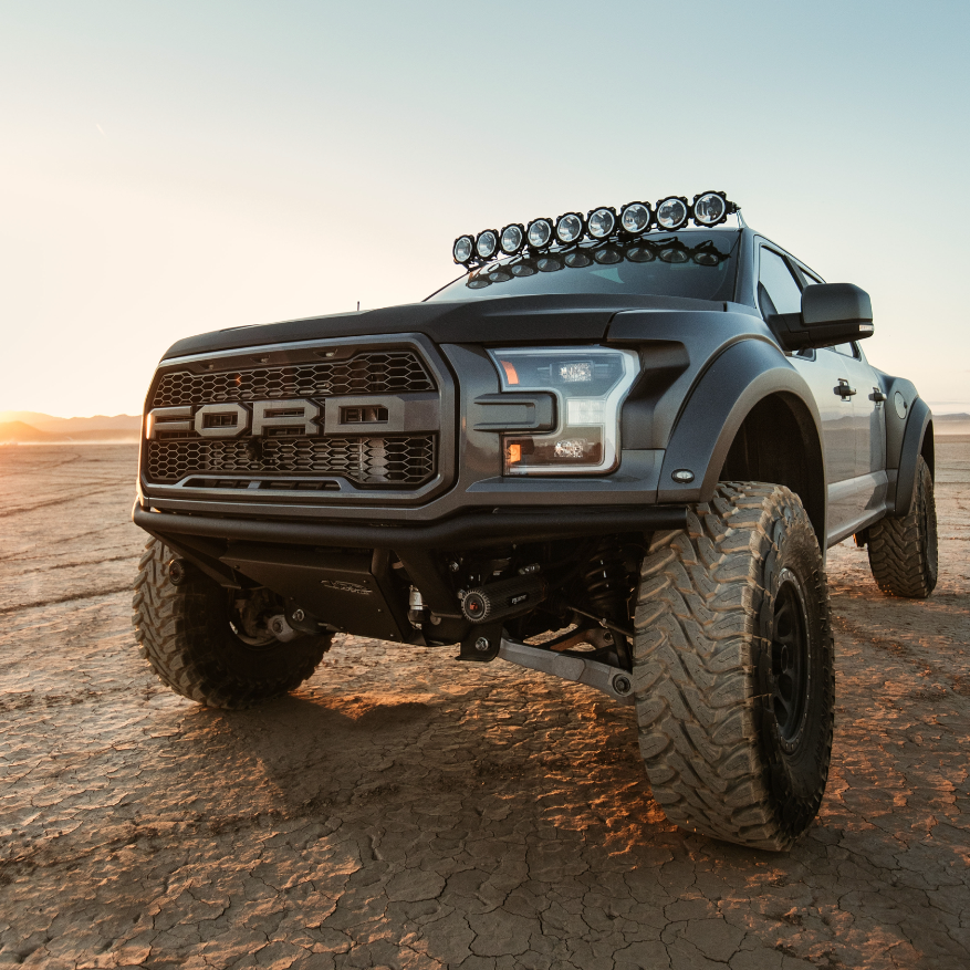 2017-2020 Ford Raptor with custom bedsides showcasing rugged design and off-road capabilities in a desert landscape.