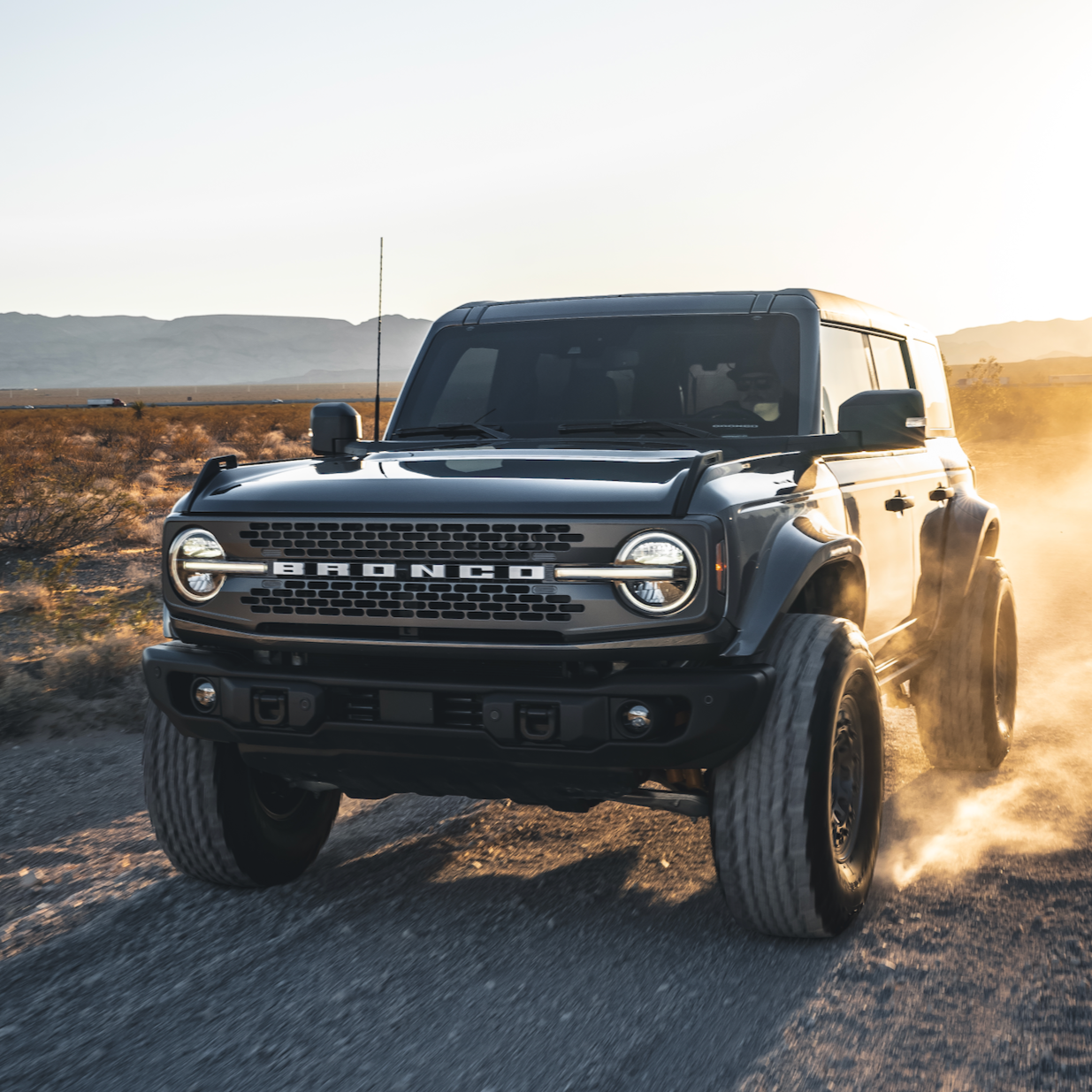2021-2025 Ford Bronco fenders on a rugged Bronco driving through a desert landscape, showcasing off-road capabilities.