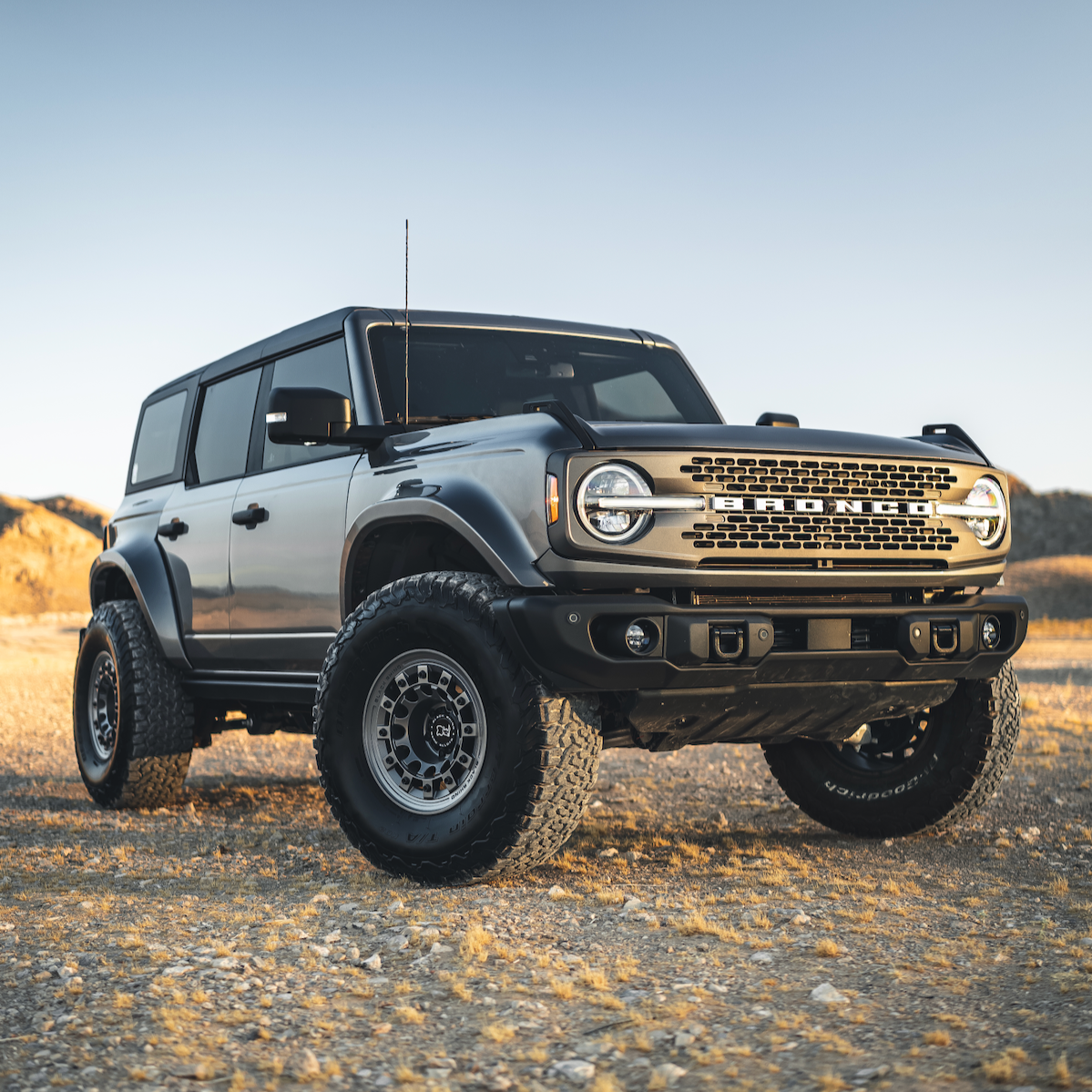 2021-2025 Ford Bronco with upgraded fenders, showcasing rugged design and off-road capability in a desert setting.