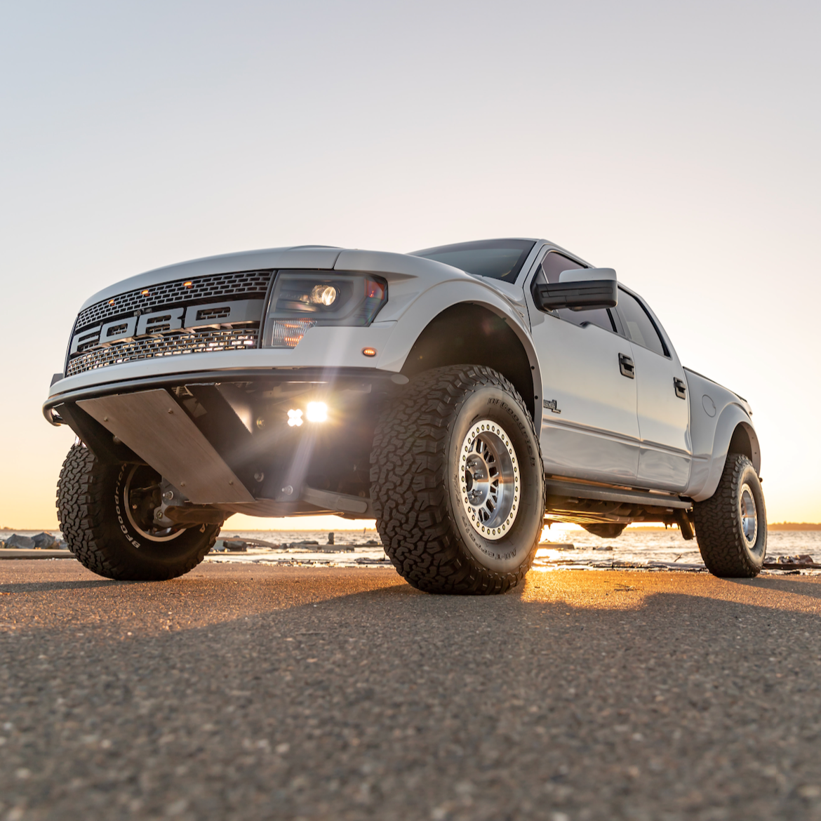 2010-2016 Ford Raptor fenders showcasing rugged design and enhanced off-road capability on a silver truck.