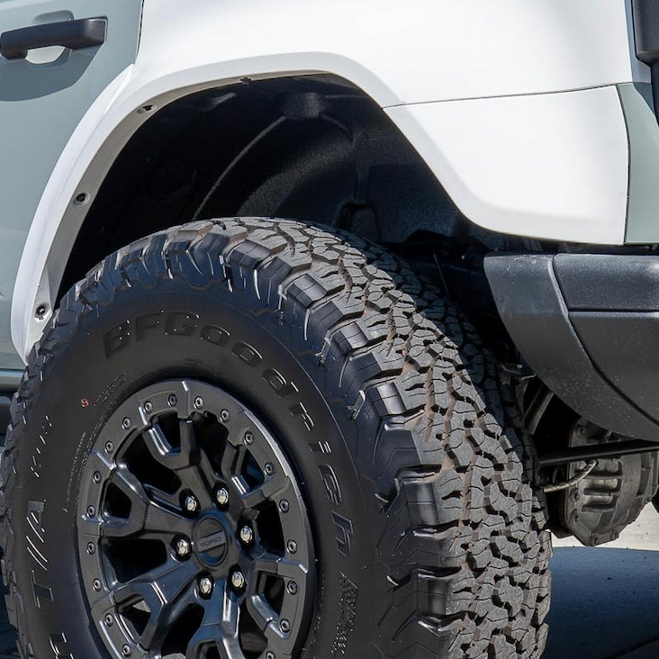 2022-2025 Ford Bronco Raptor rear quarter kit showcasing rugged tire and wheel design for enhanced offroad performance.