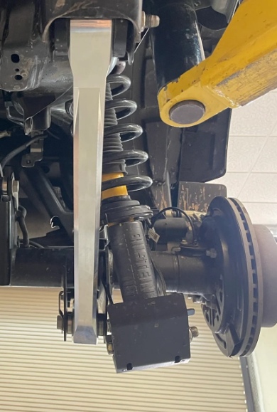 2021 and up Bronco rear suspension featuring lower billet aluminum arms, showcasing the suspension setup and components.